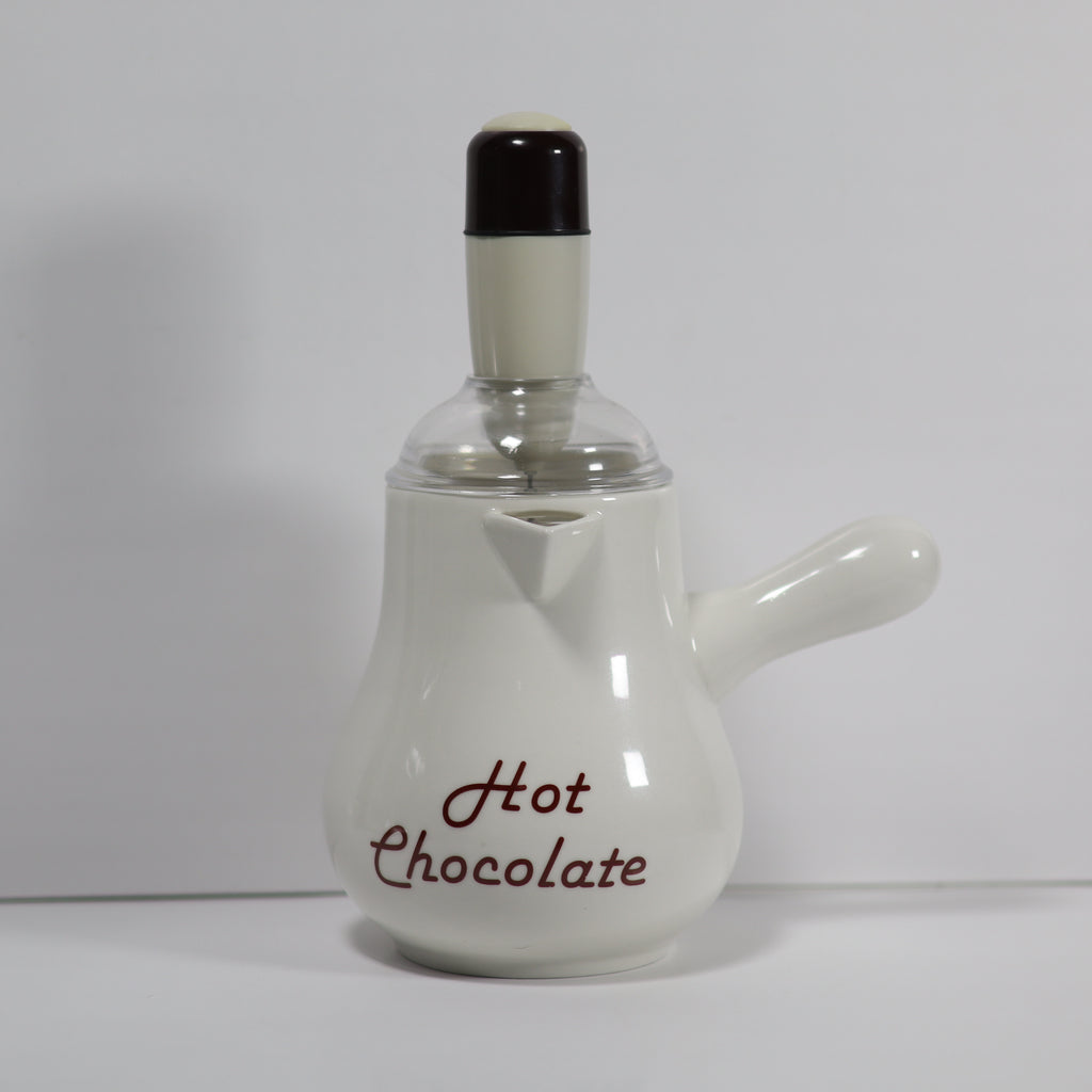 White ceramic hot chocolate pot with black lid on a white background