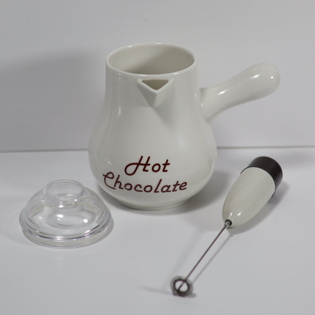 White ceramic pot labeled 'Hot Chocolate' with a clear lid and milk frother on a white background