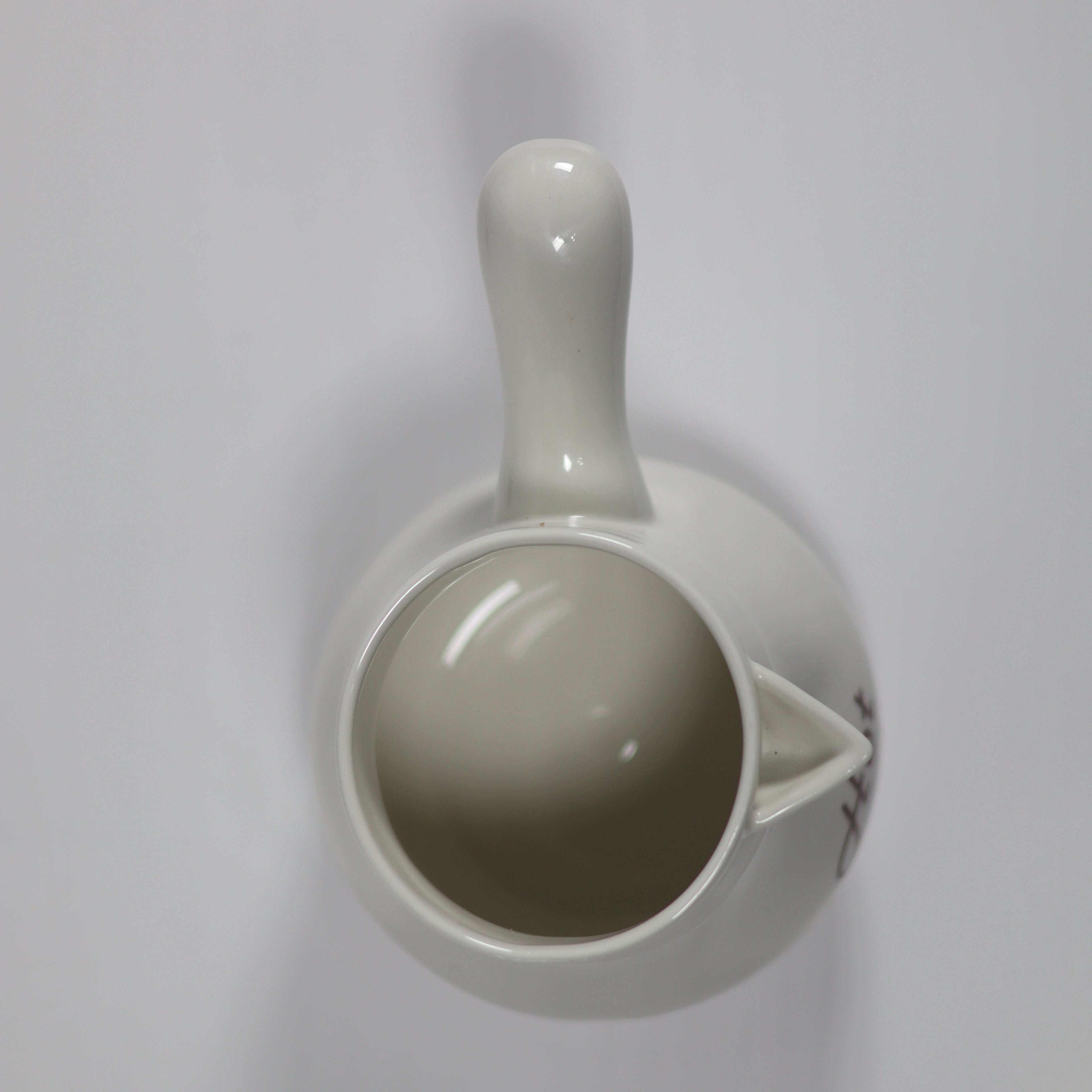 White ceramic pitcher on a white background