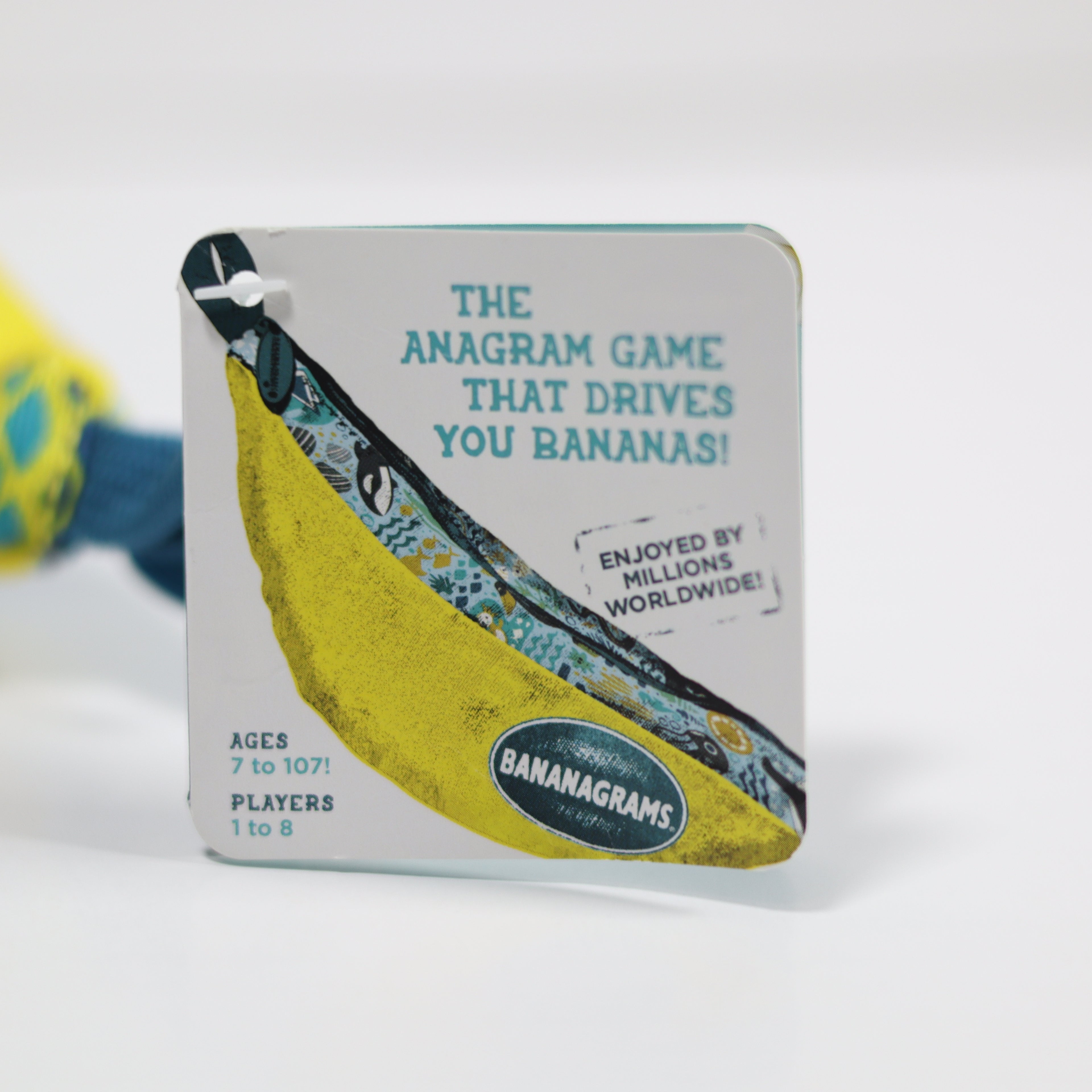 Banana-shaped packaging for 'Bananagrams' game on a white background