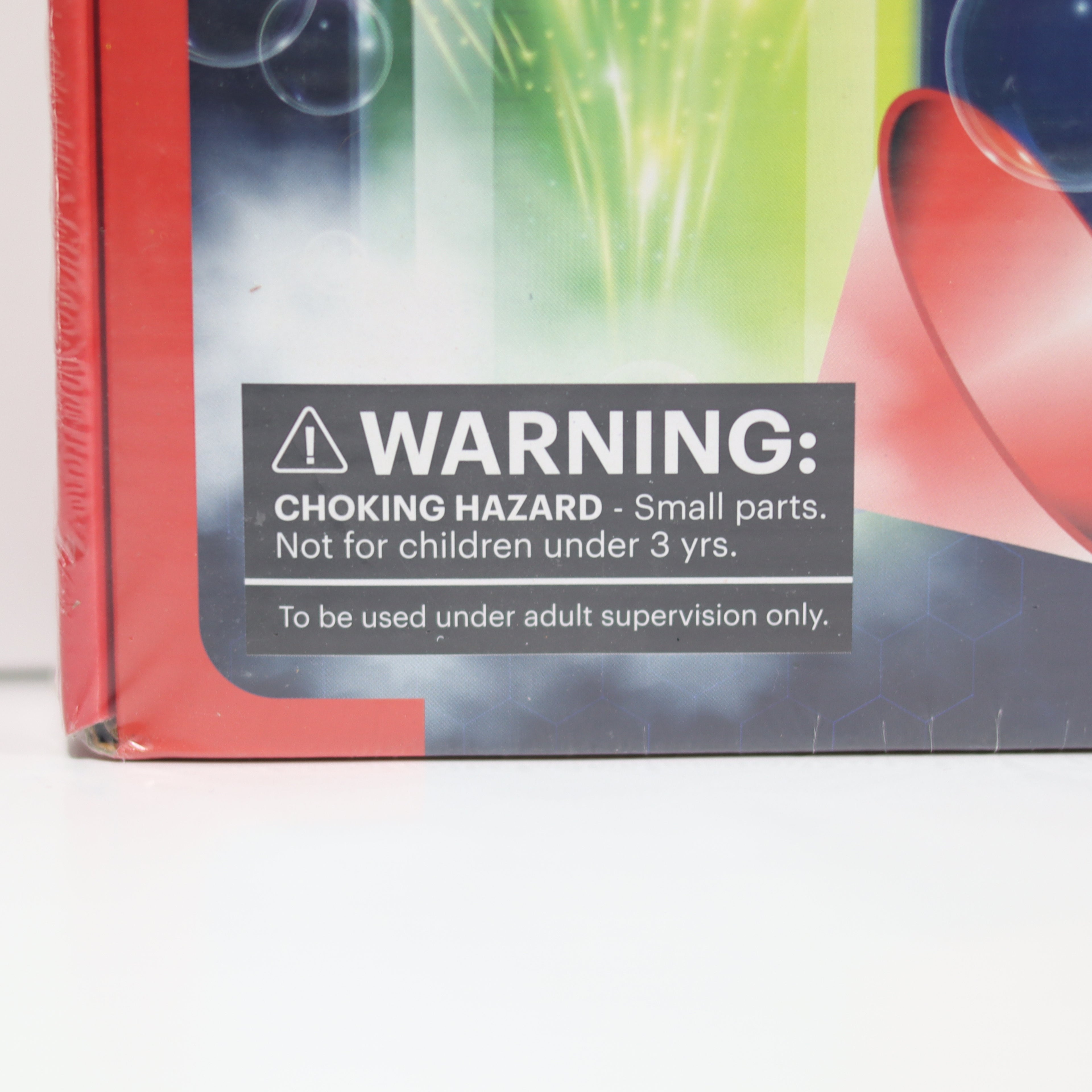 Product packaging with a choking hazard warning label on a white surface