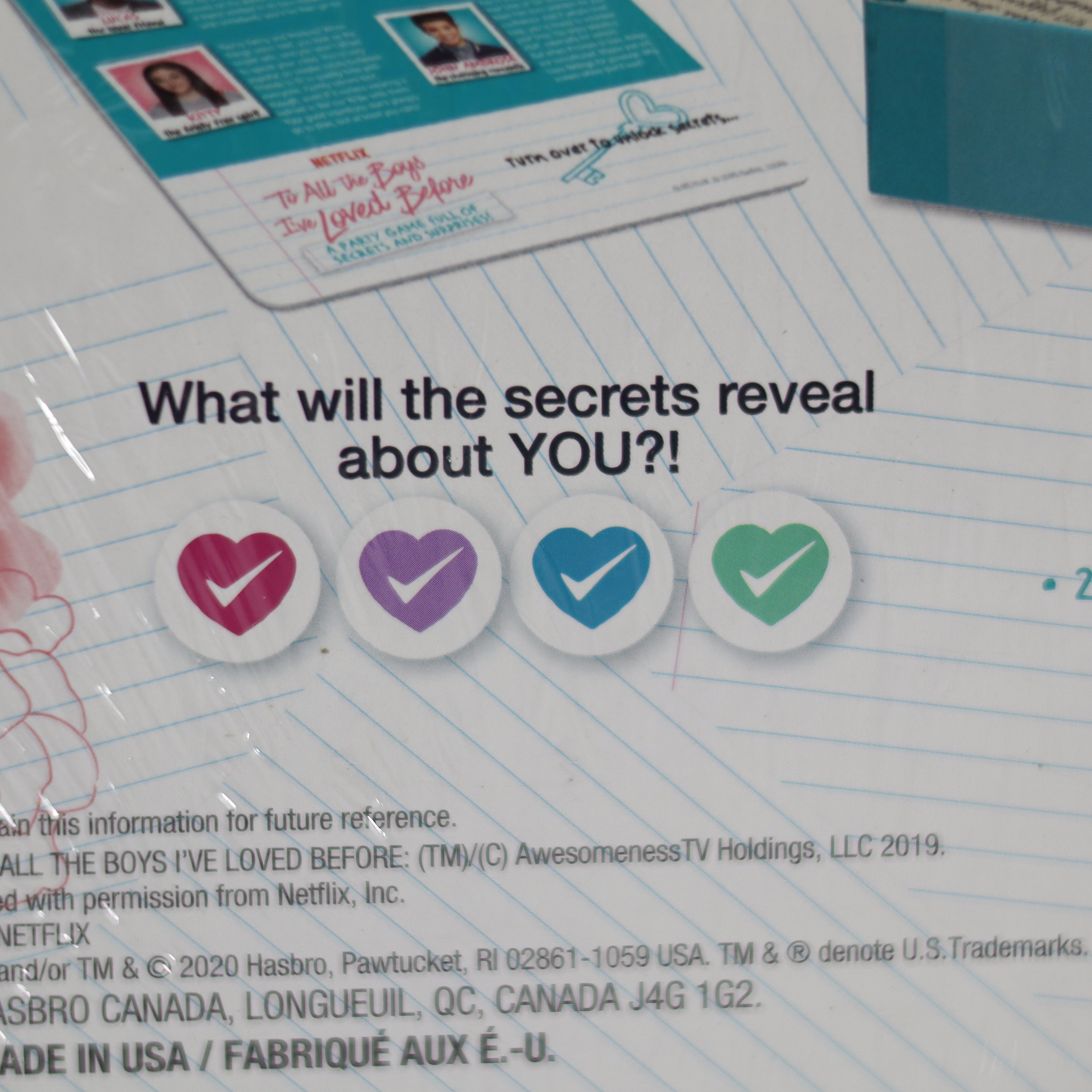 Promotional material with heart icons and text asking 'What will the secrets reveal about YOU?' on a lined paper background.