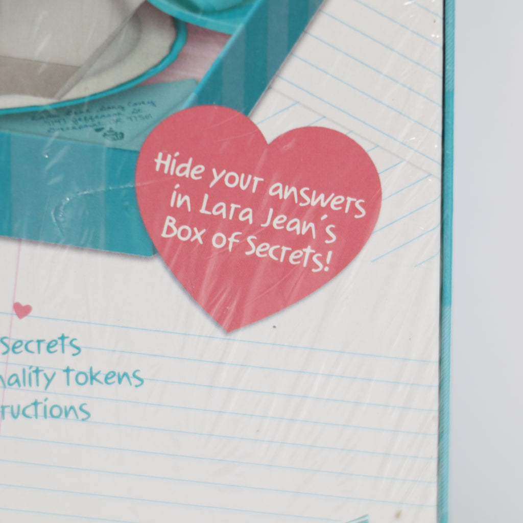 Notebook with a heart-shaped sticker reading 'Hide your answers in Lara Jean's Box of Secrets!'