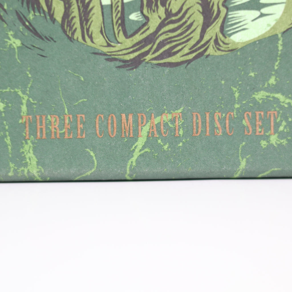 Compact disc set packaging with green design and text 'THREE COMPACT DISC SET'.