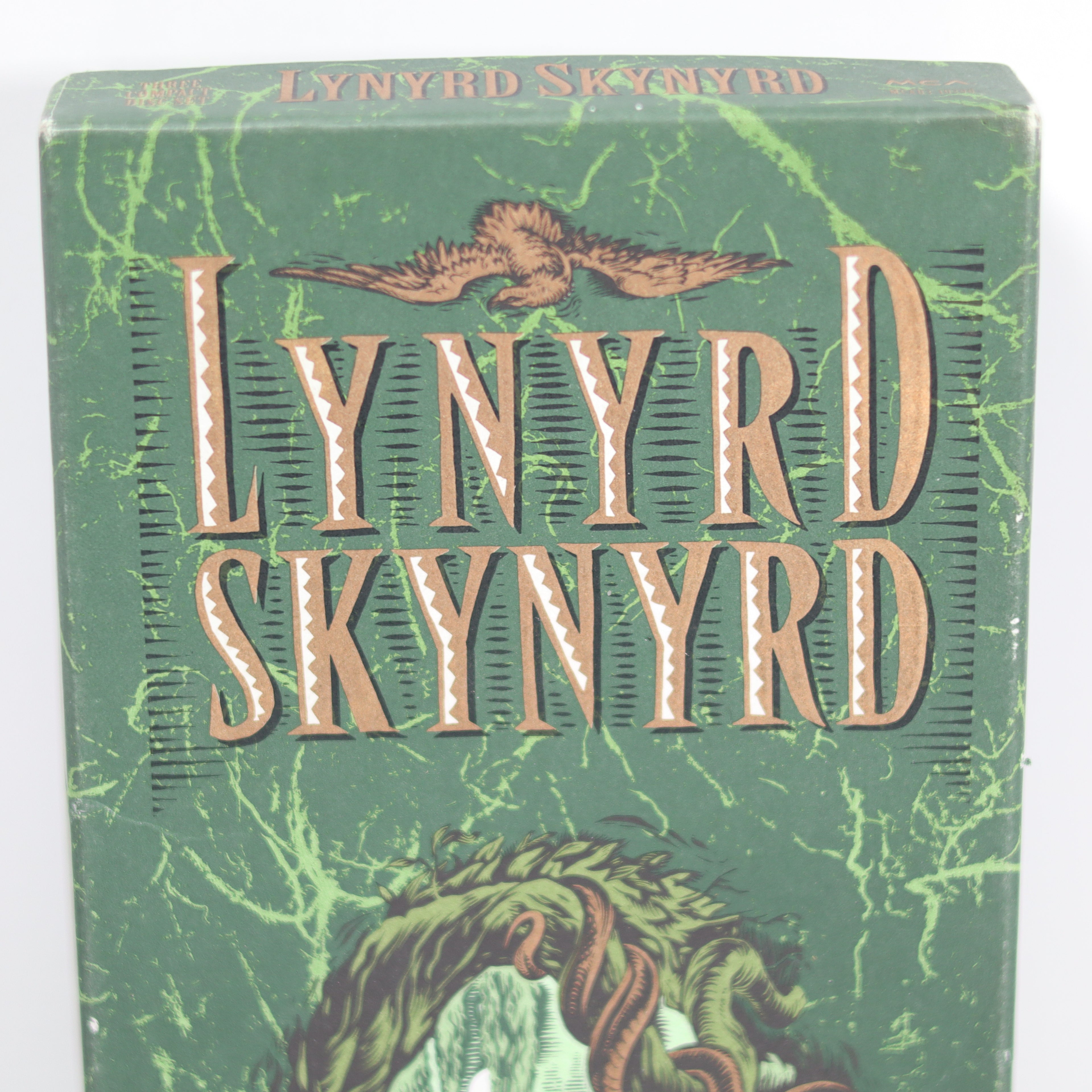 Green album cover with 'Lynyrd Skynyrd' branding and illustrations of snakes.