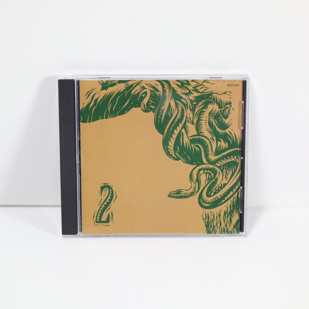 CD case with green leaf design on a beige background