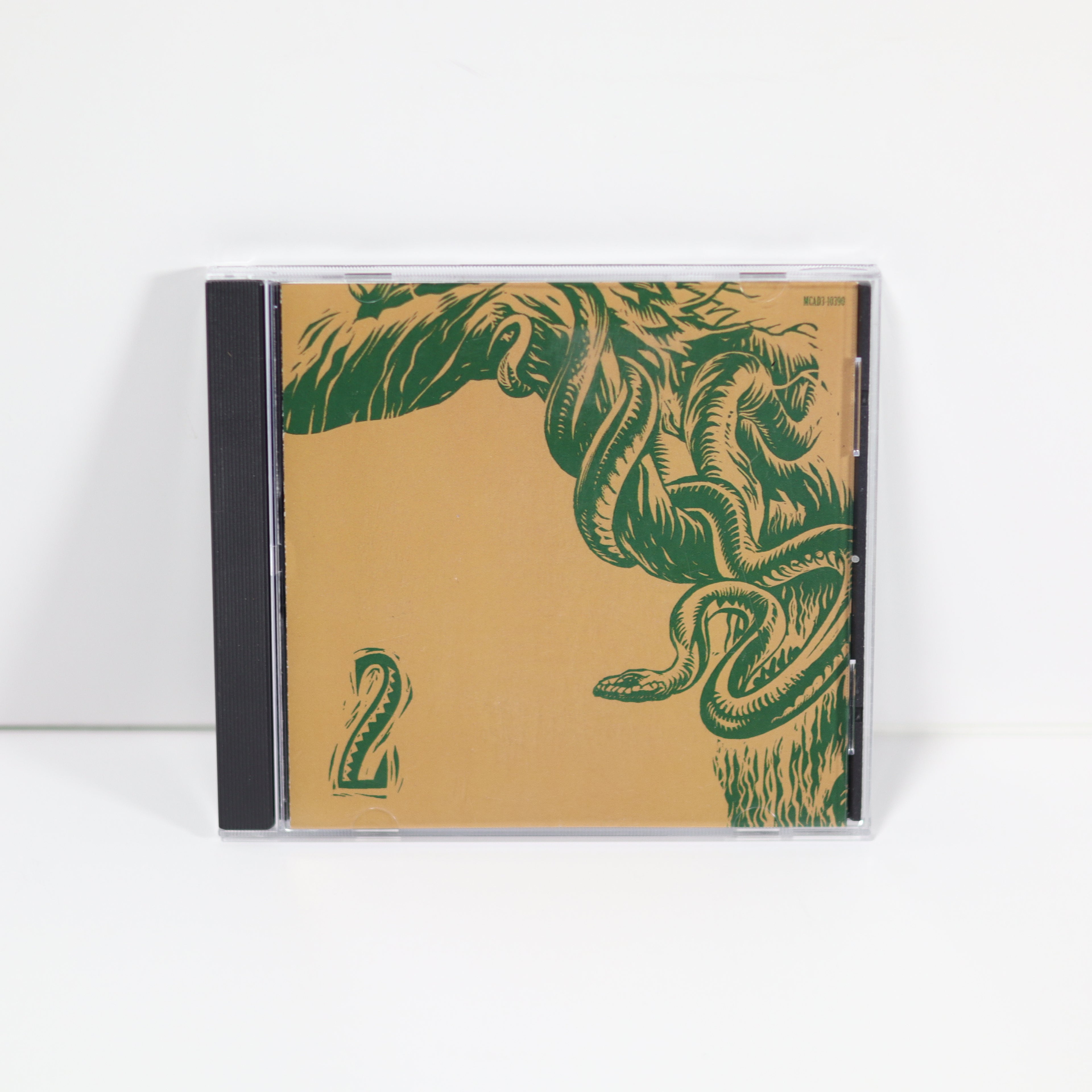 CD case with green leaf design on a beige background
