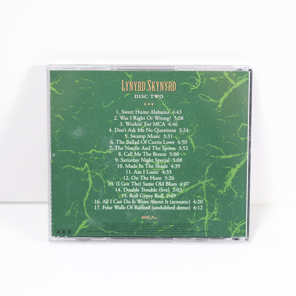 CD case with green marbled design and white text listing track names and times, on a white background.