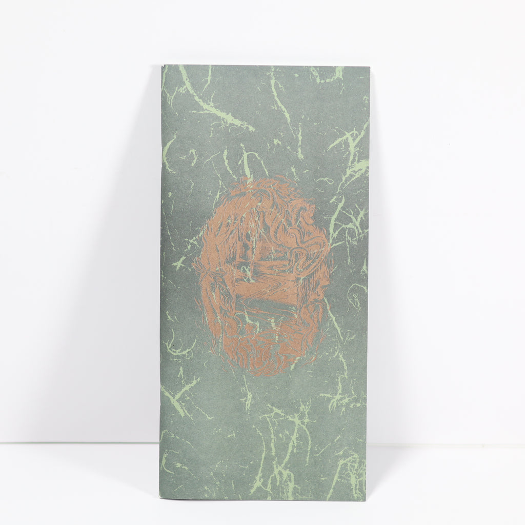 Notebook with a green marbled cover and a brown logo on a white background