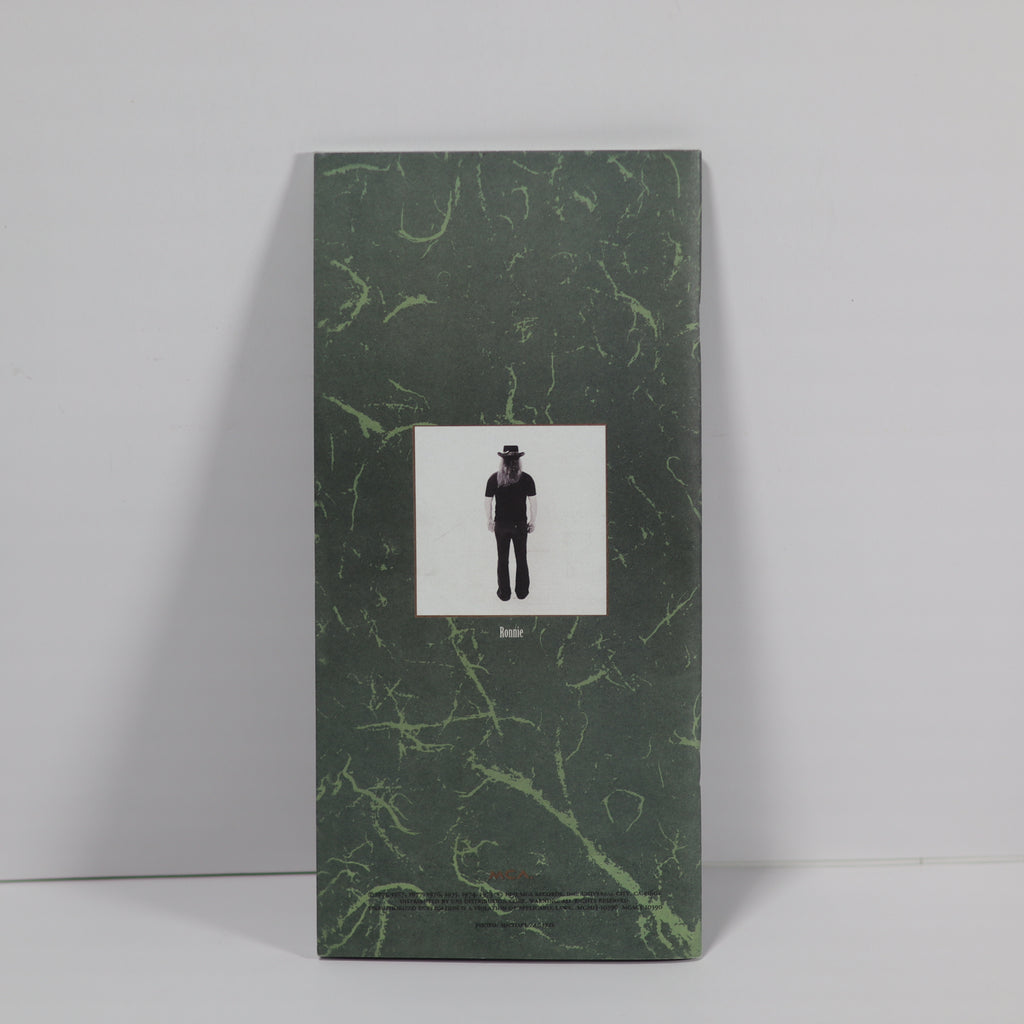 Green marbled book with a black and white illustration on a gray background