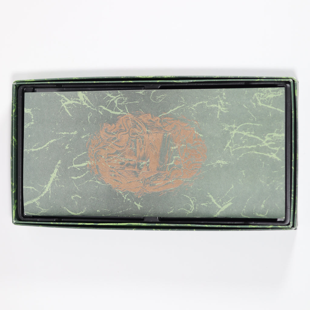 Rectangular product with marbled green design and embossed logo on a white background