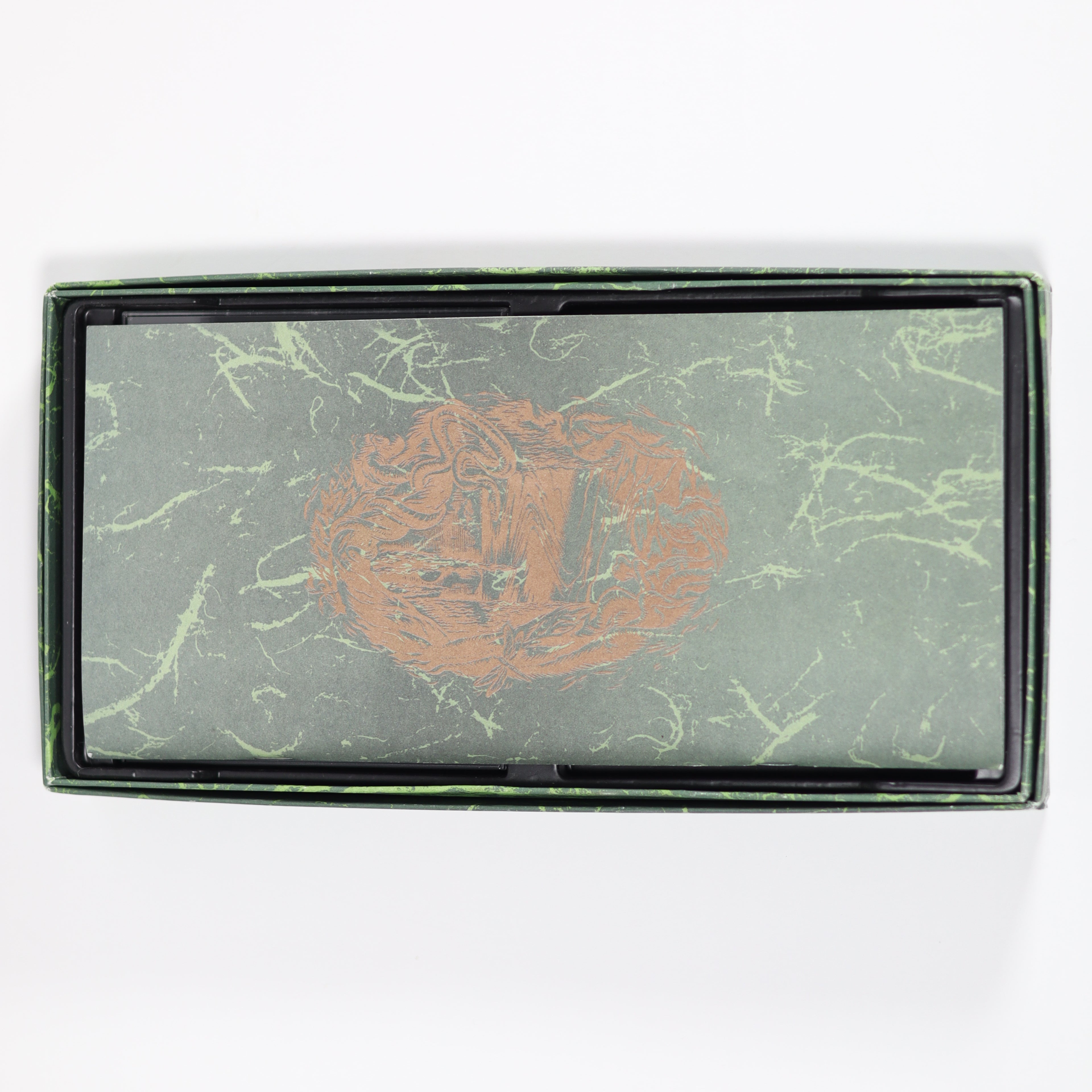 Rectangular product with marbled green design and embossed logo on a white background