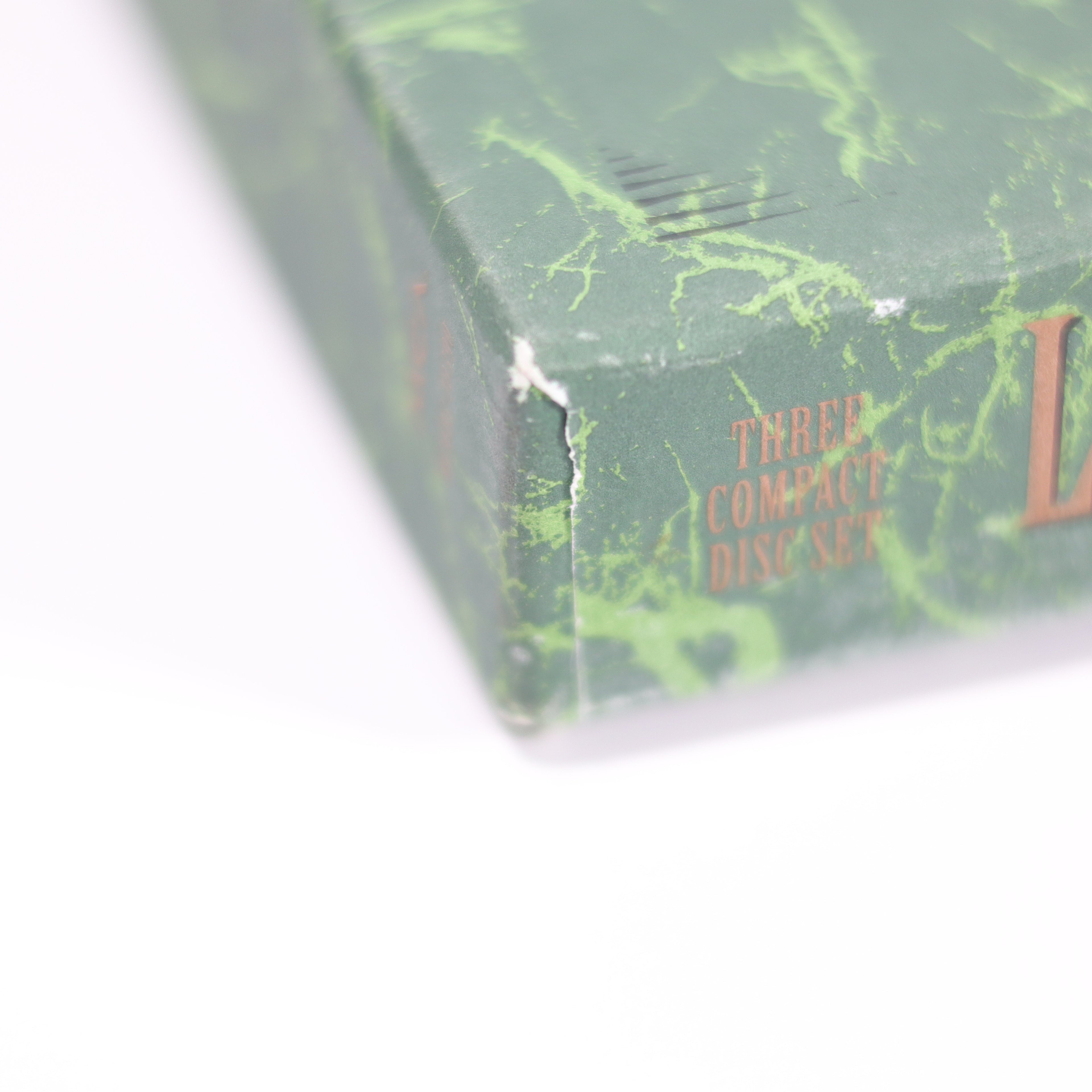 Green marbled box with text on a white background
