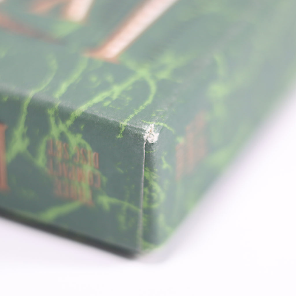 Close-up of a green book with red text on a white background