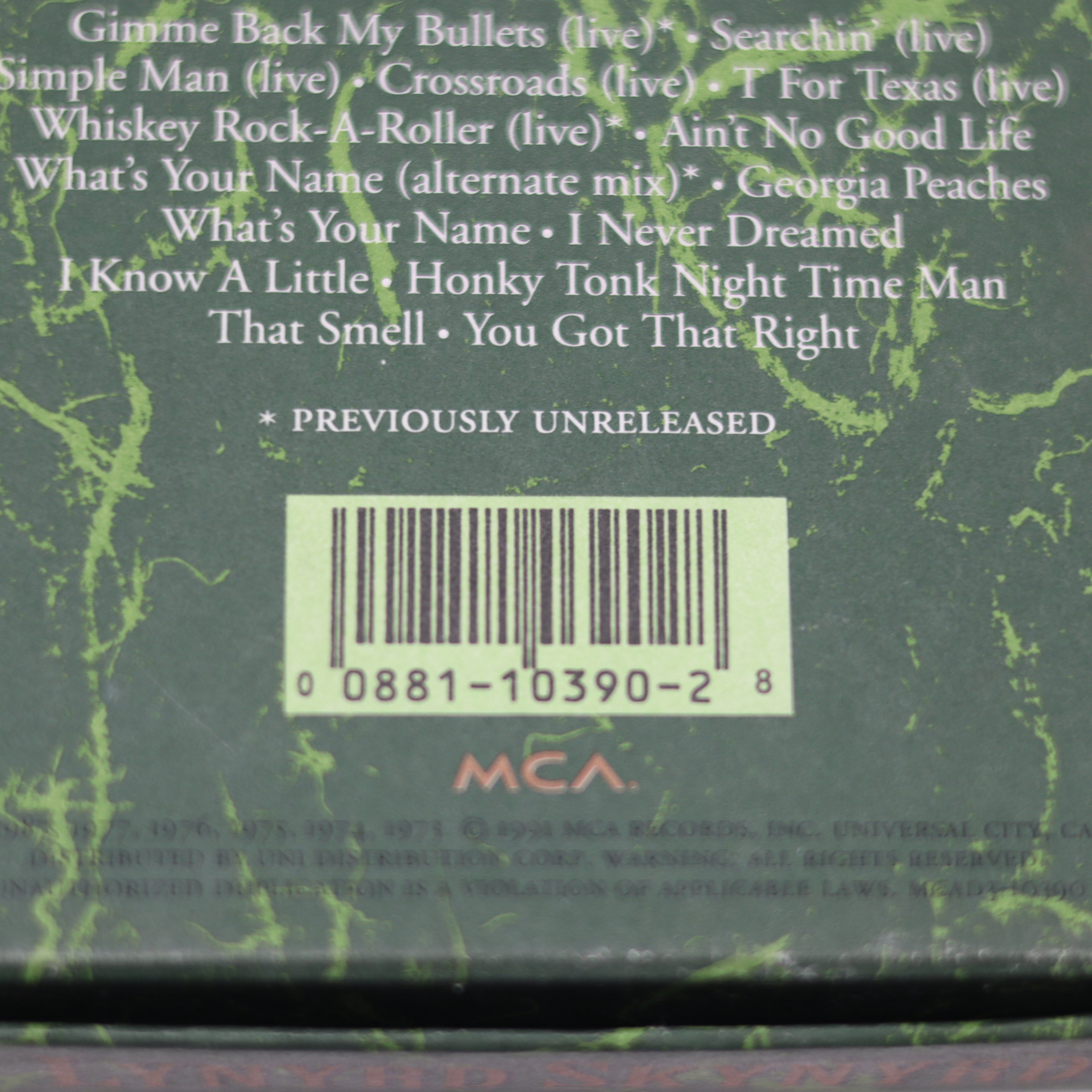 Back cover of a music album with tracklist and barcode on a green textured background