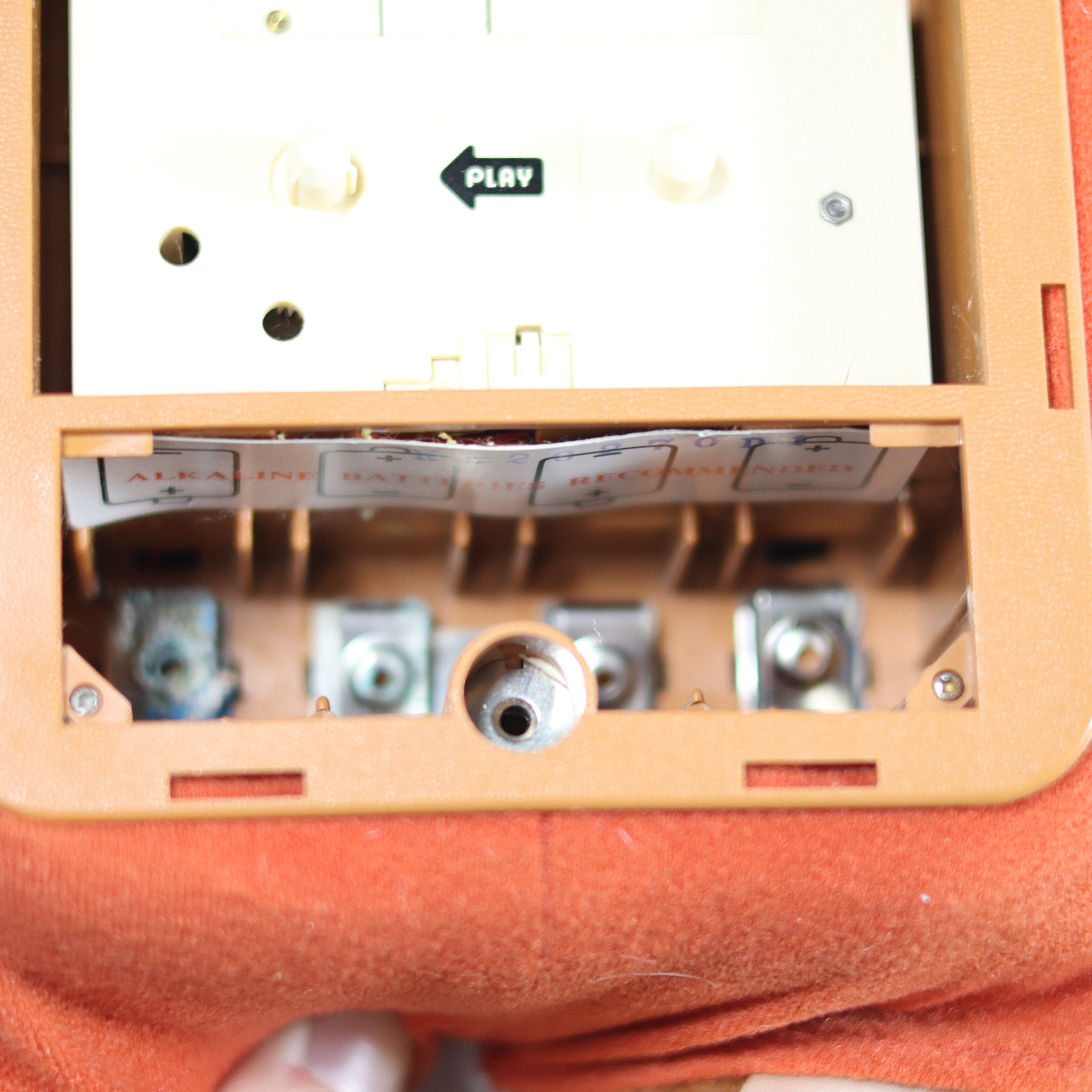Close-up of a vintage cassette tape player with a cassette inside.