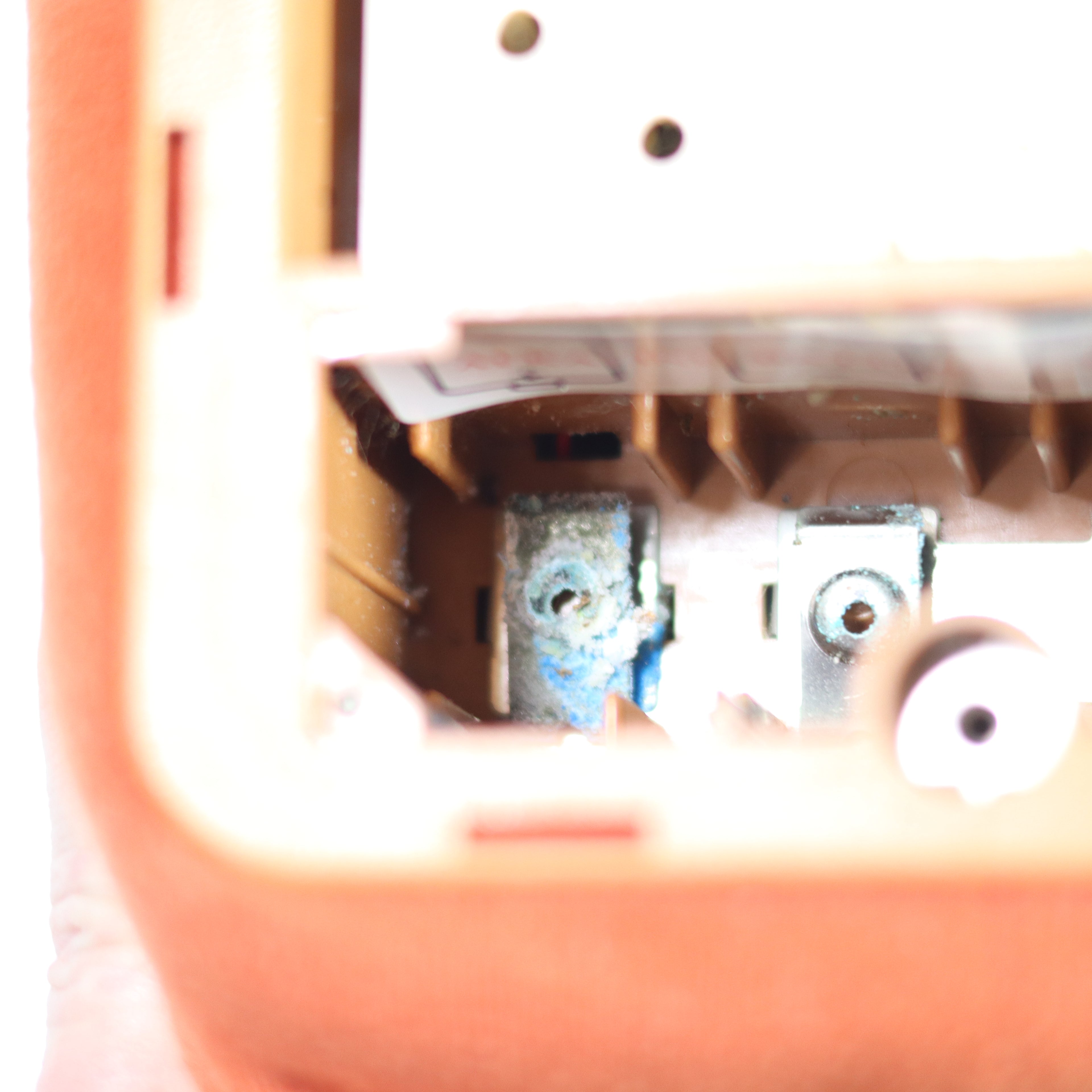 Close-up of a mechanical device inside a pink container