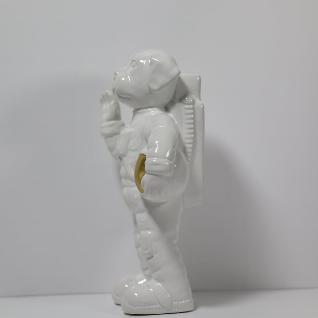 White ceramic astronaut figurine on a plain background
