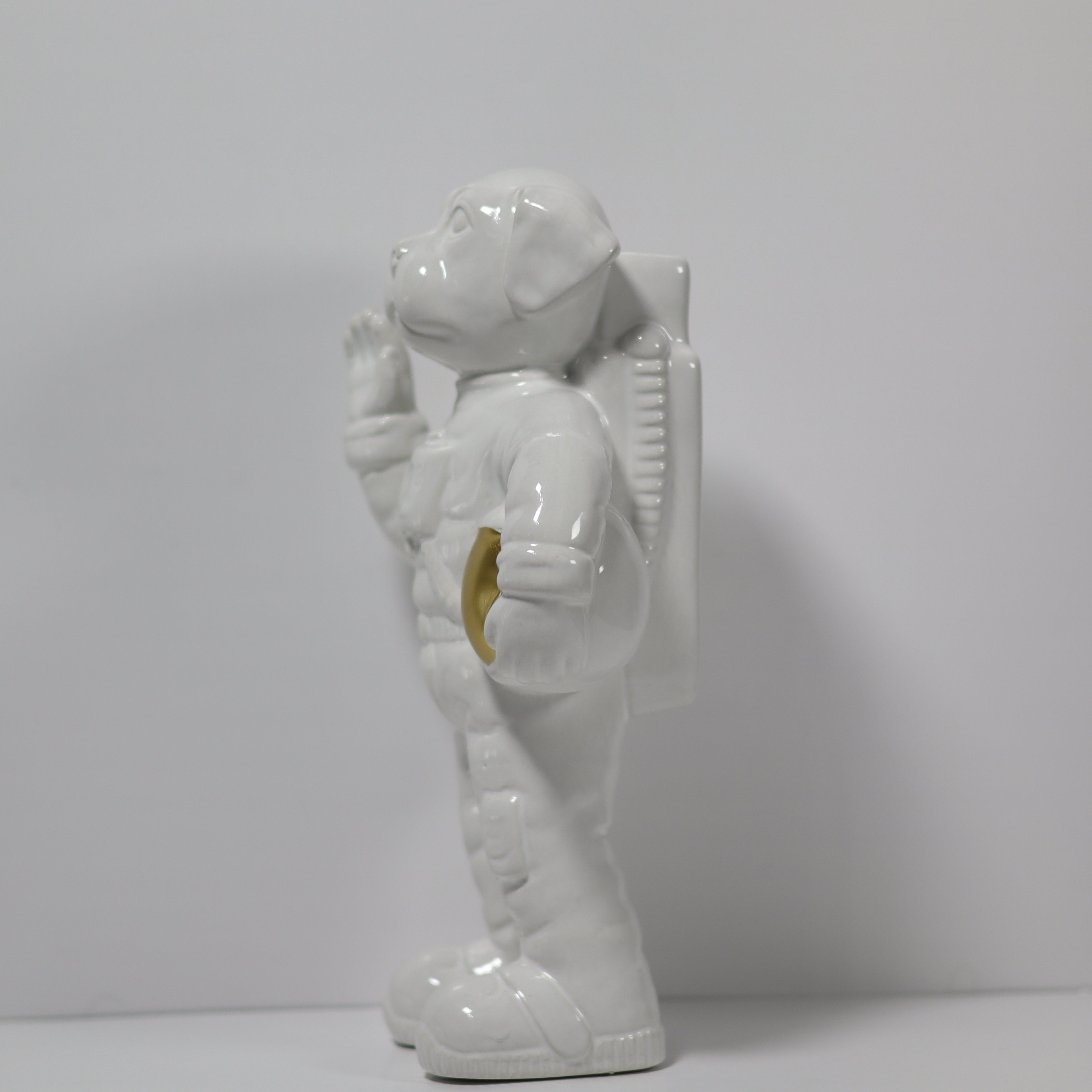 White ceramic astronaut figurine on a plain background