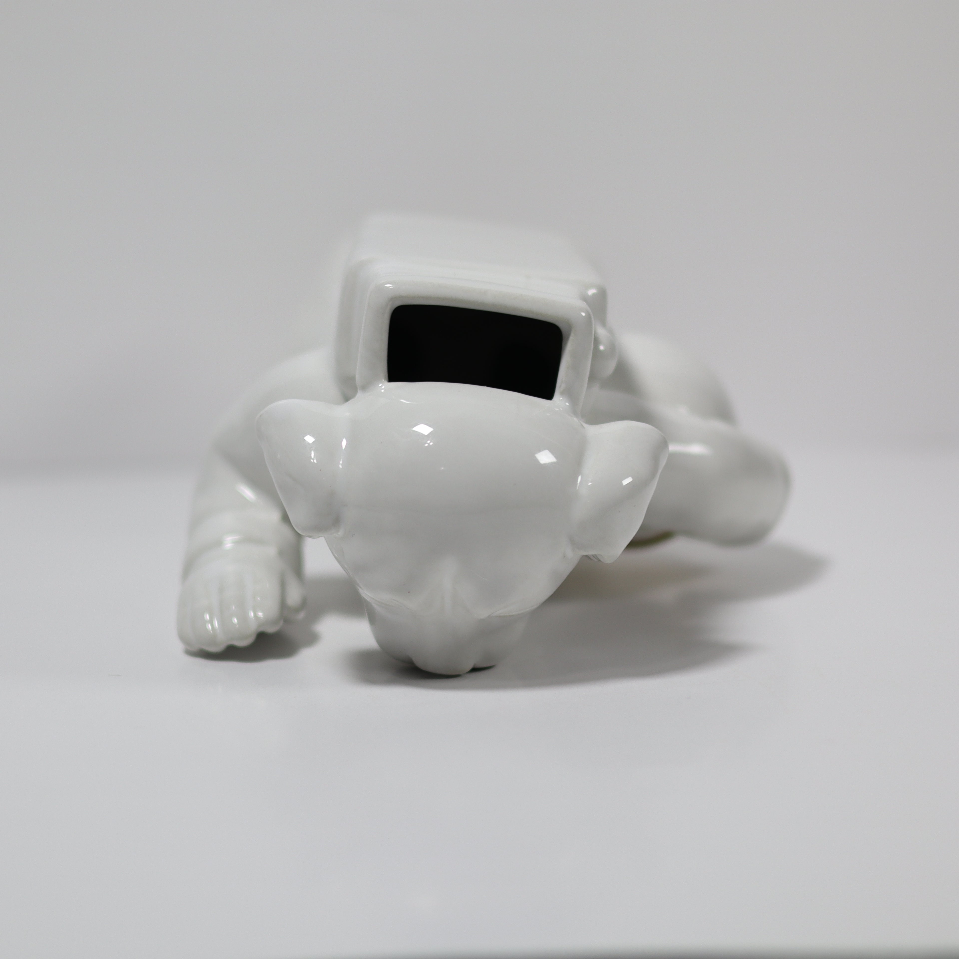 White robot-like figure on a light gray background