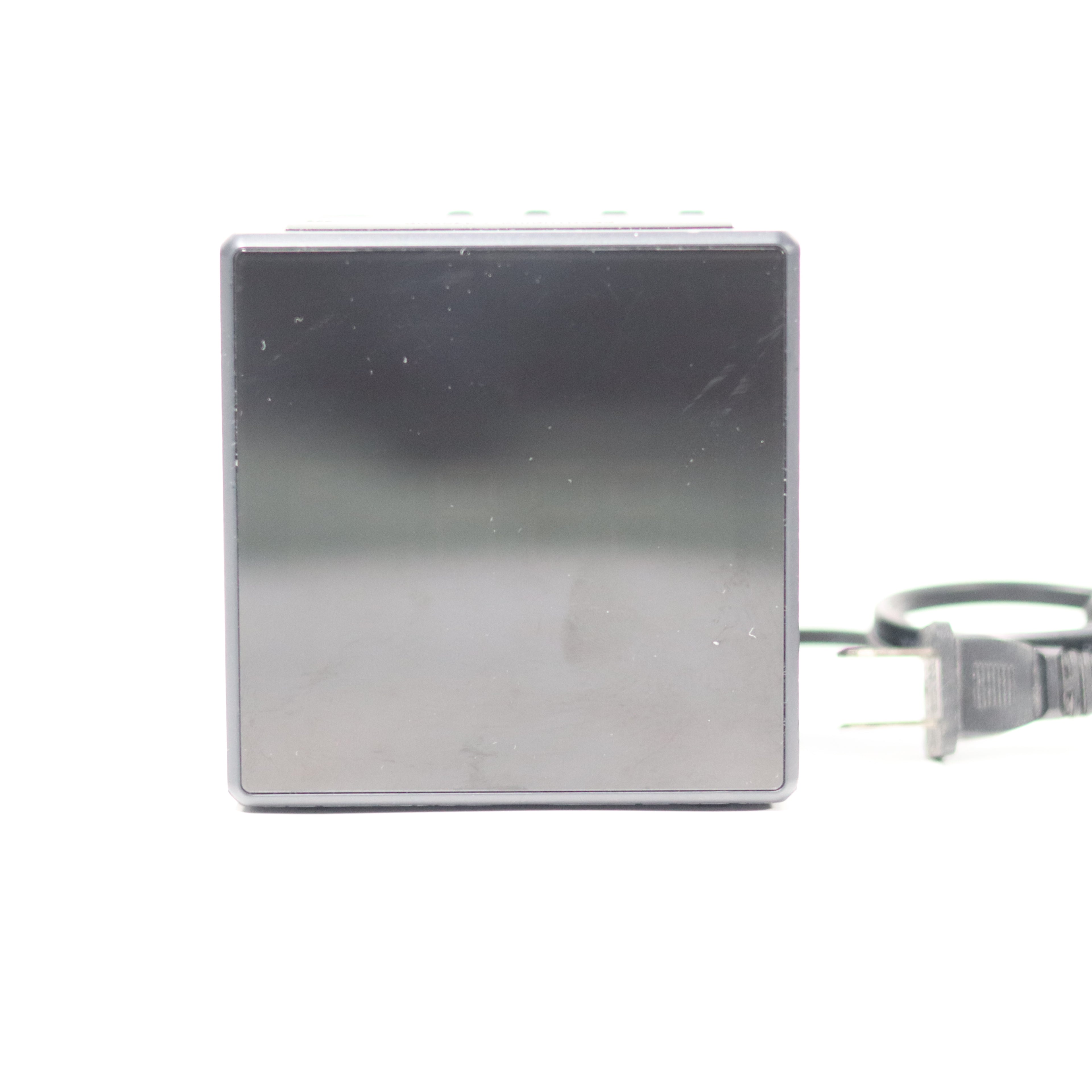 Rectangular metal device with a power cord on a white background