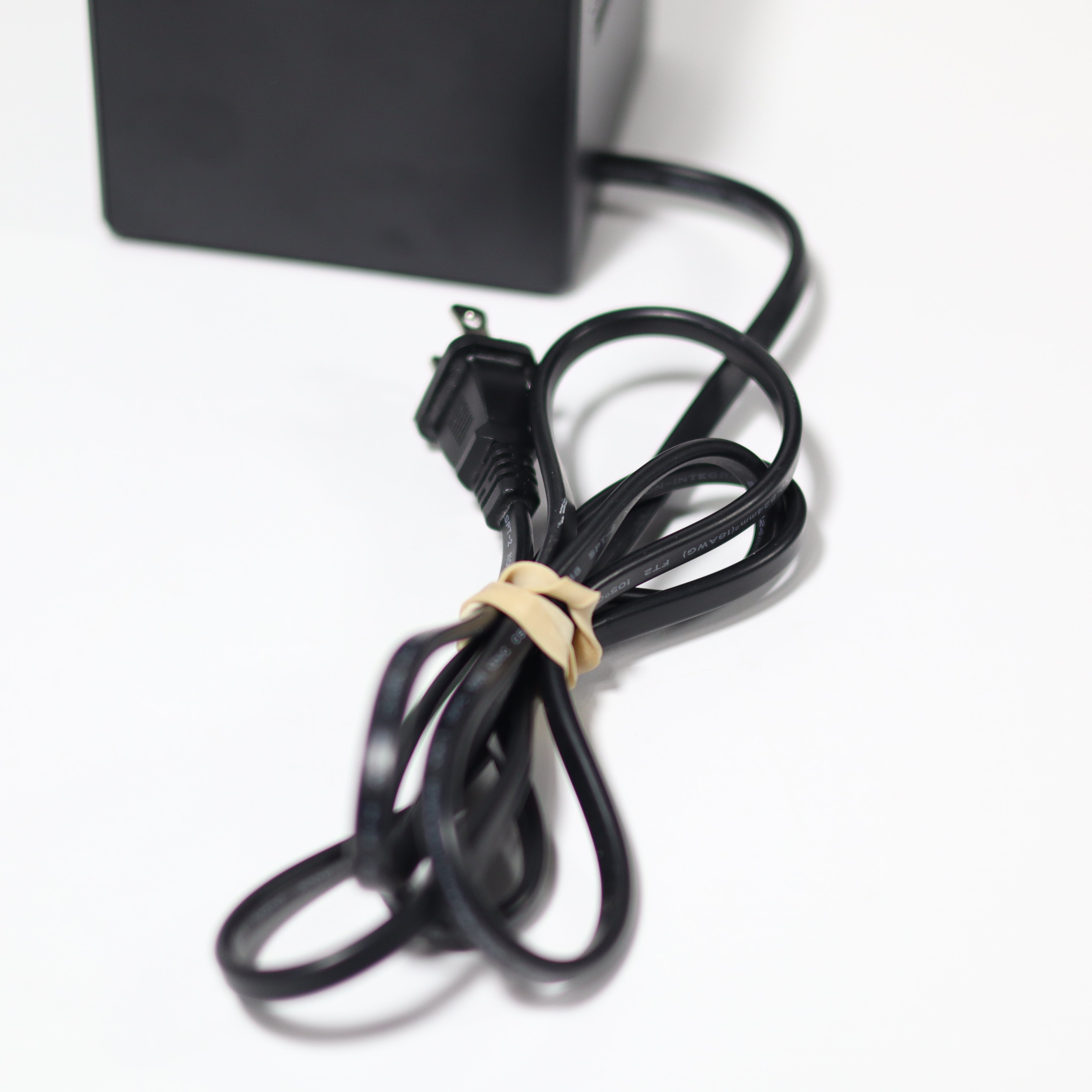 Black power cord with plug on a white background