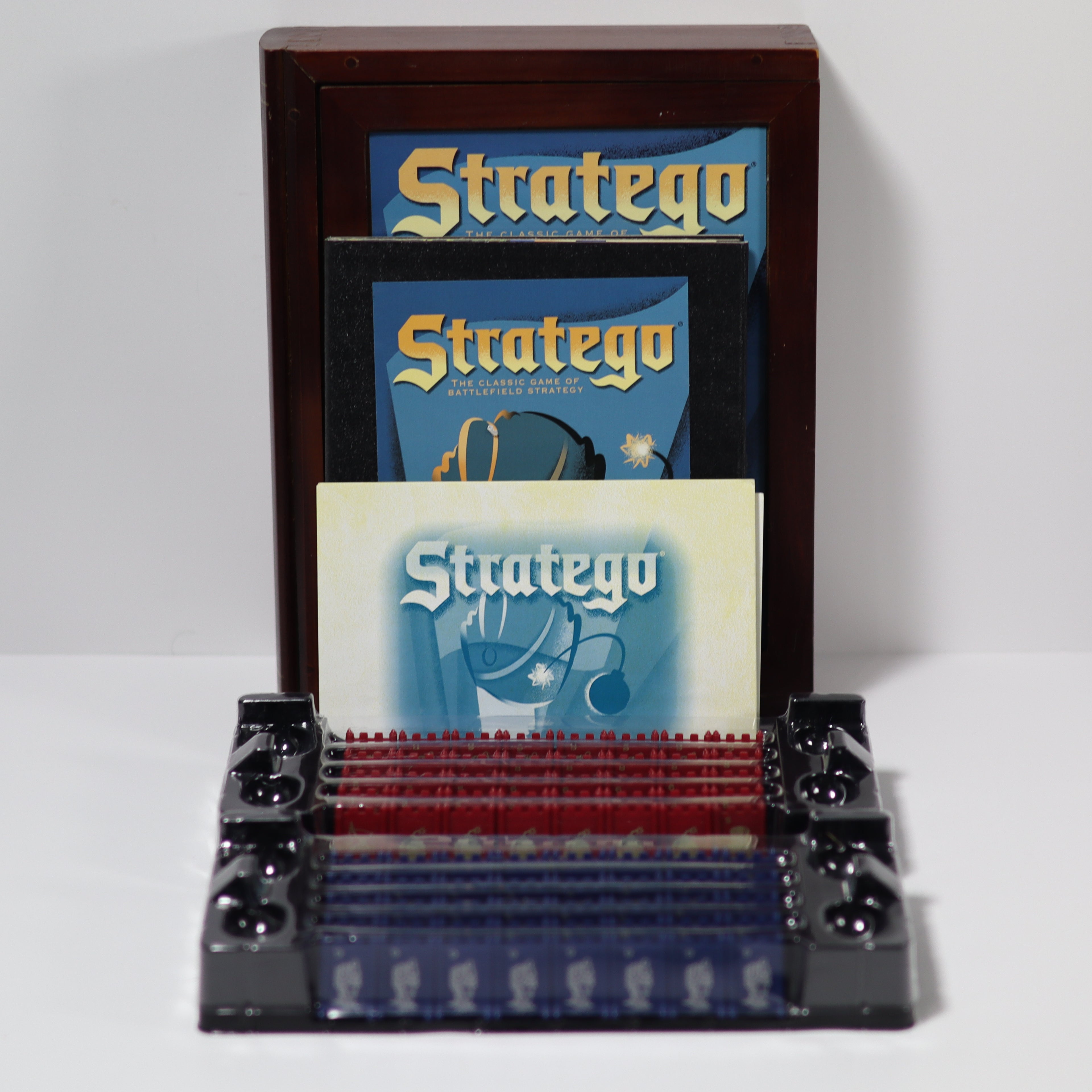 Stratego board game set with cards and pieces on a white background