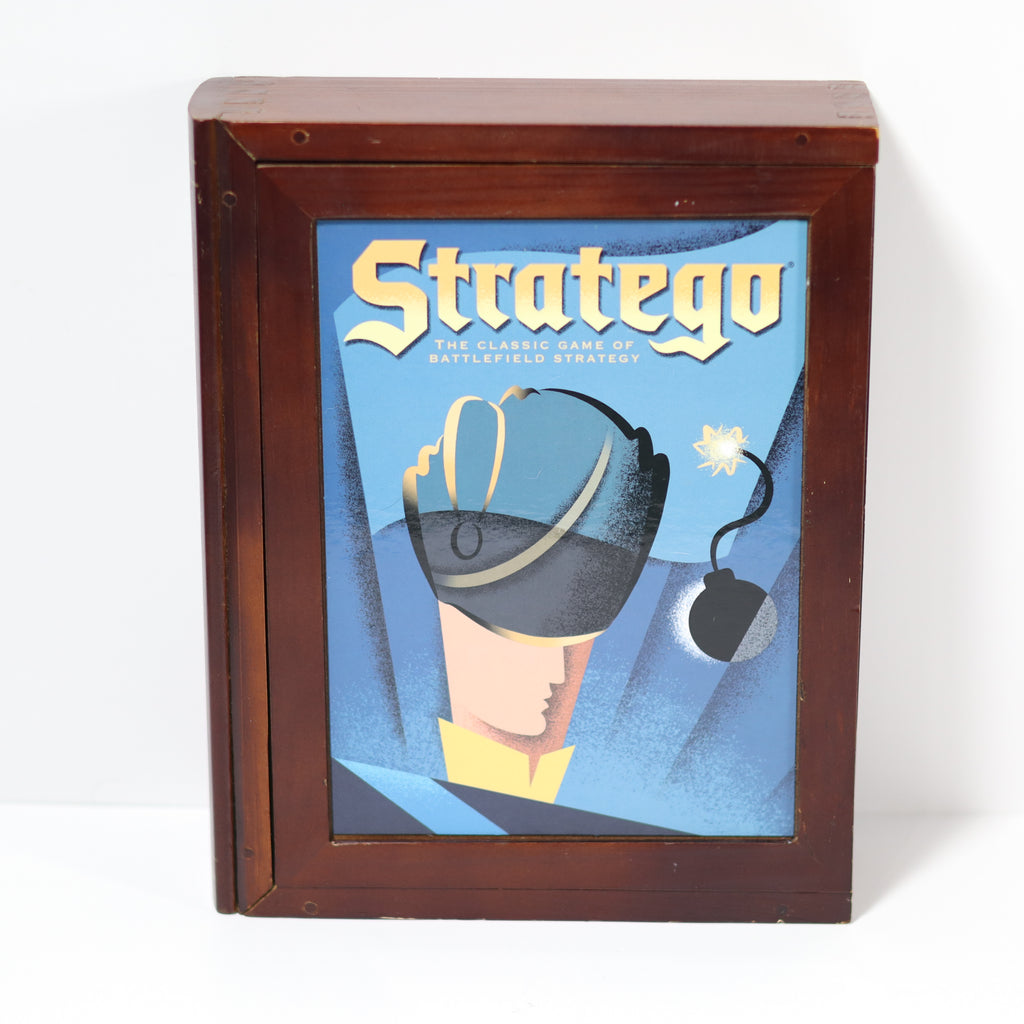 Wooden box with 'Stratego' game cover featuring a soldier and bomb on a blue background.