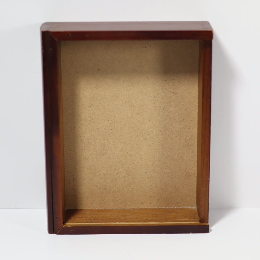 Wooden display box with brown interior on a white background