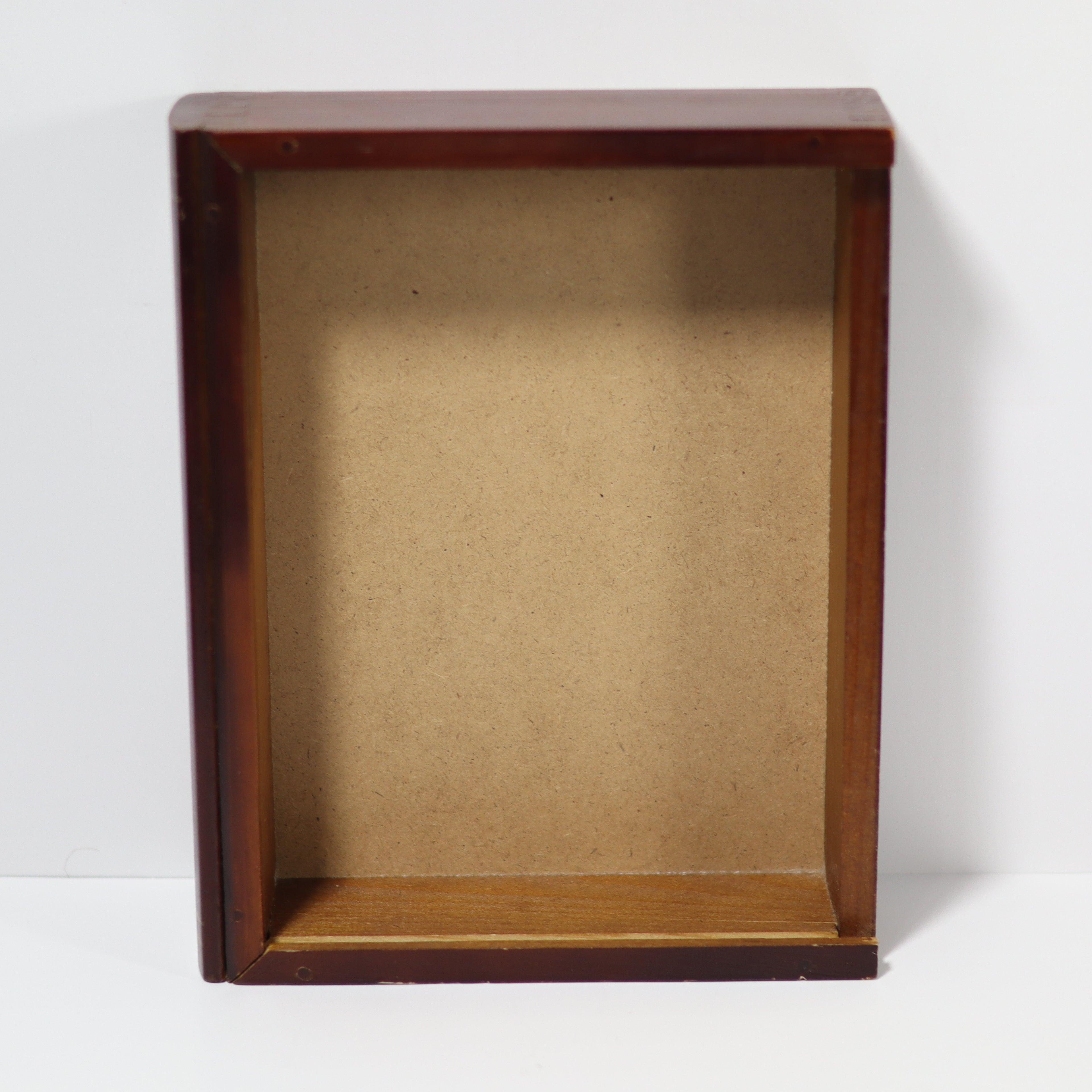Wooden display box with brown interior on a white background