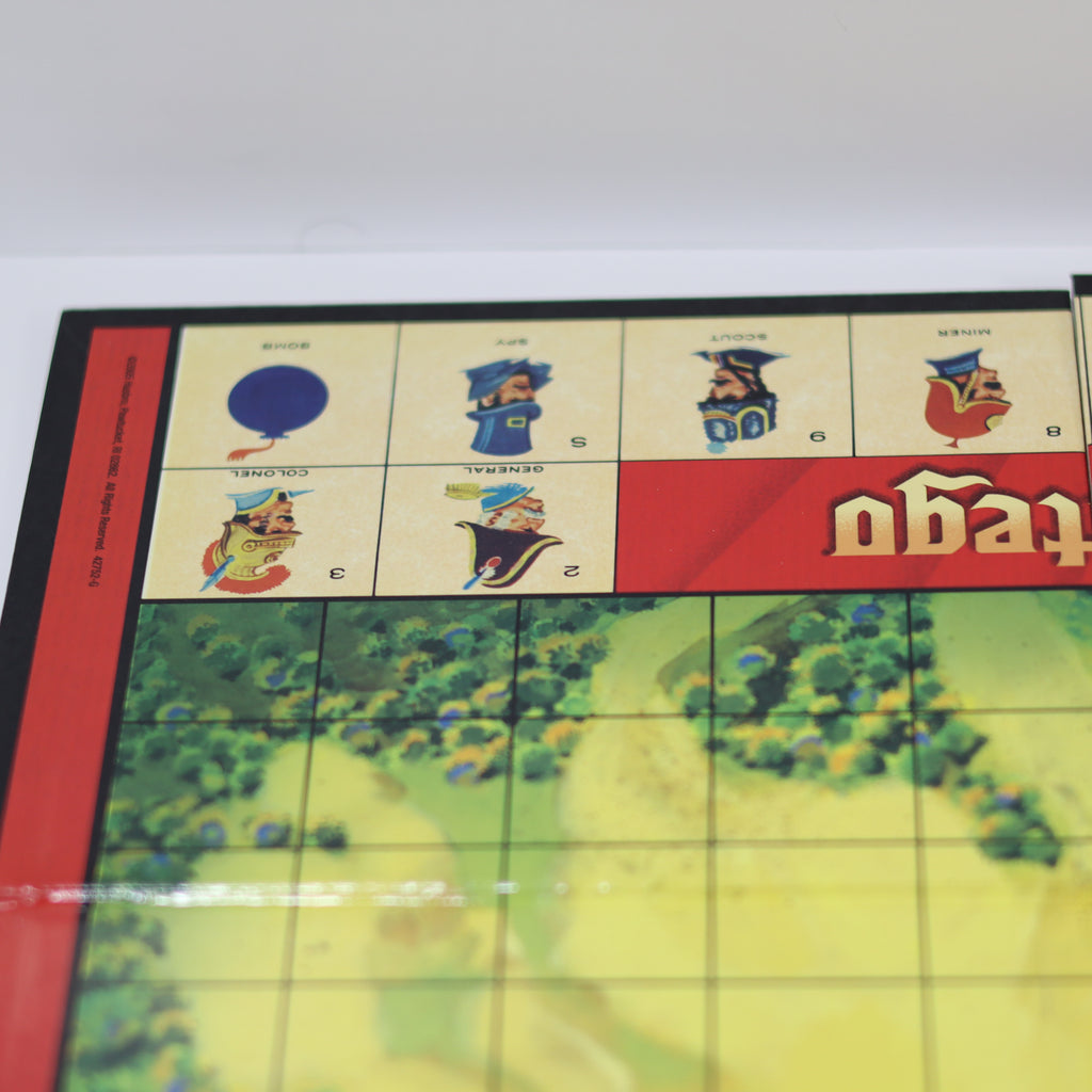 Close-up of a board game with colorful tiles and character illustrations on a white background