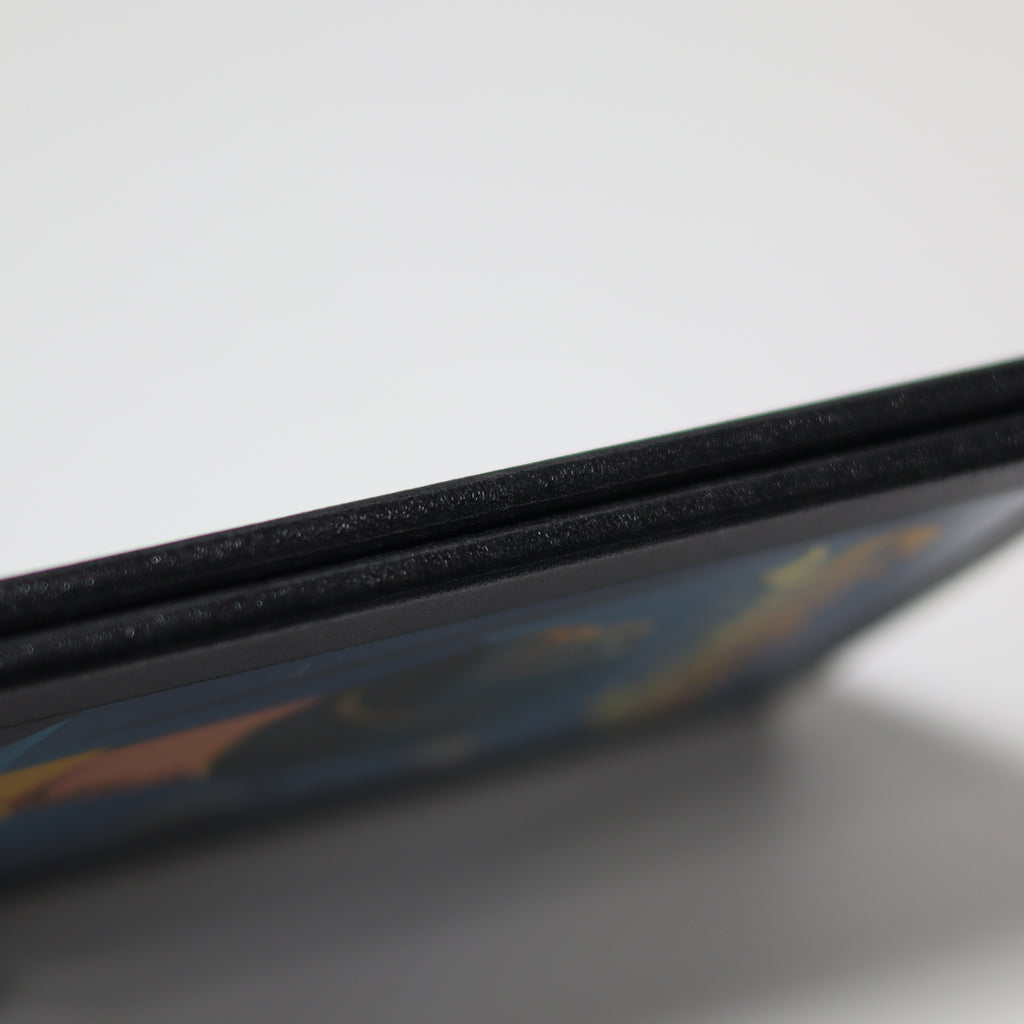 Close-up of a gameboard edge on a reflective surface with a blurred background