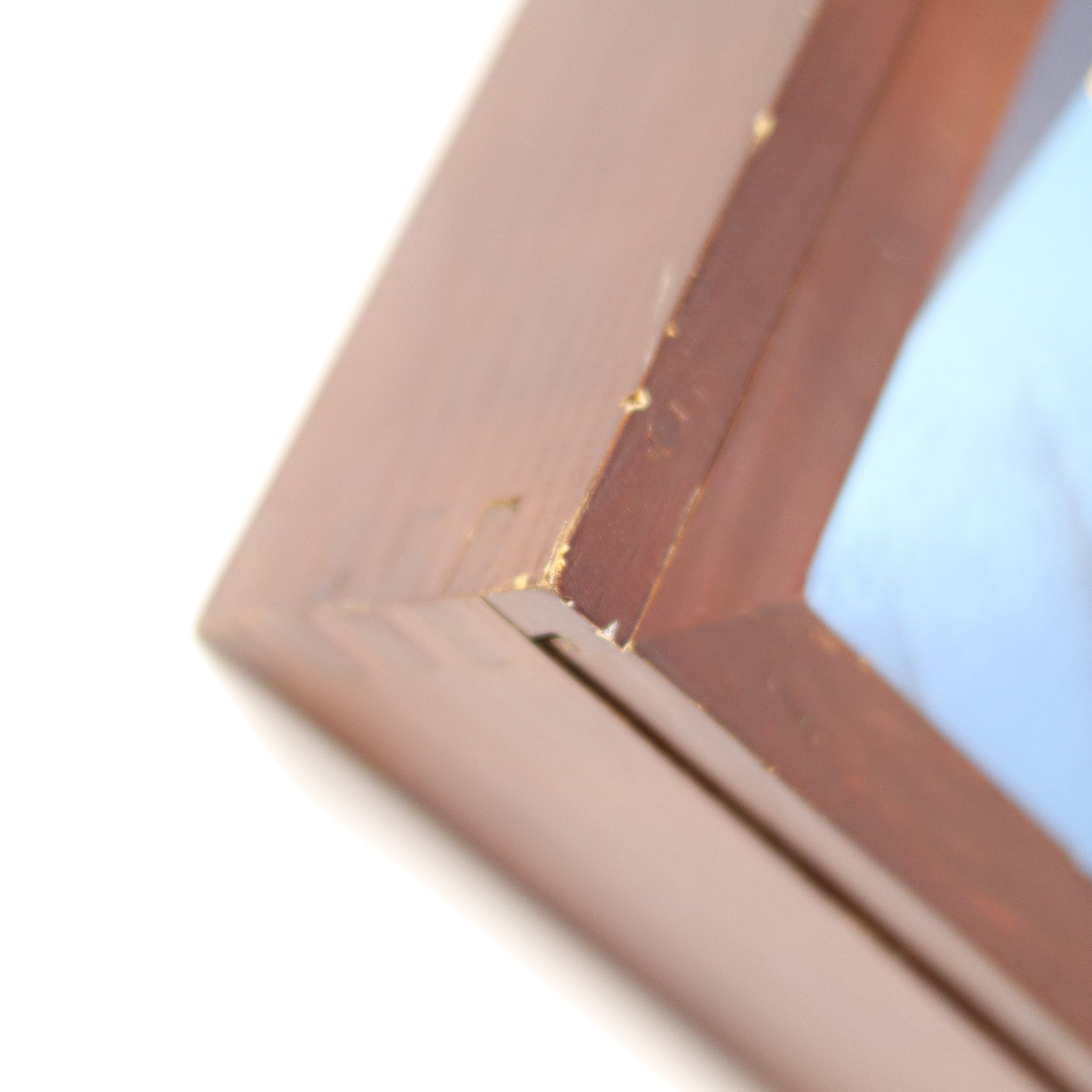 Close-up of a corner with a brown frame and white interior.