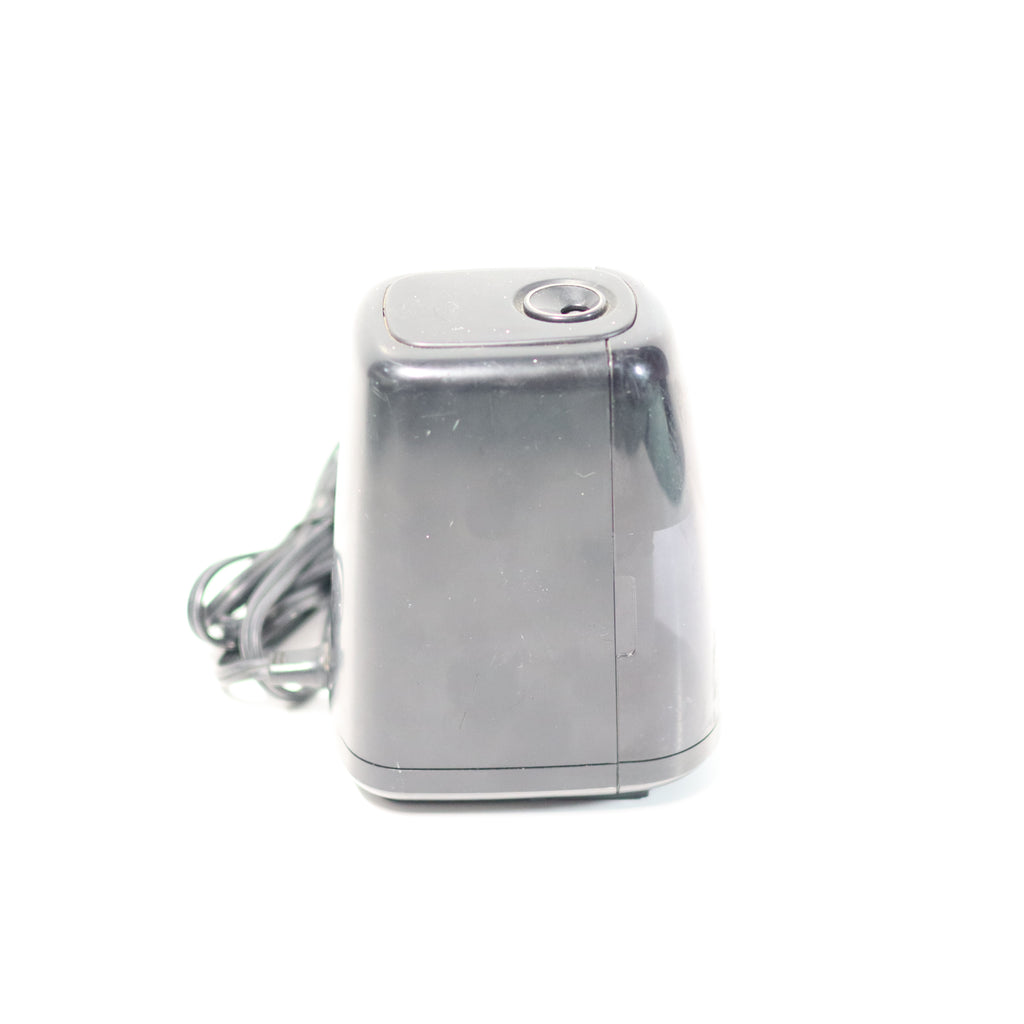 Silver electronic device with a cord on a white background