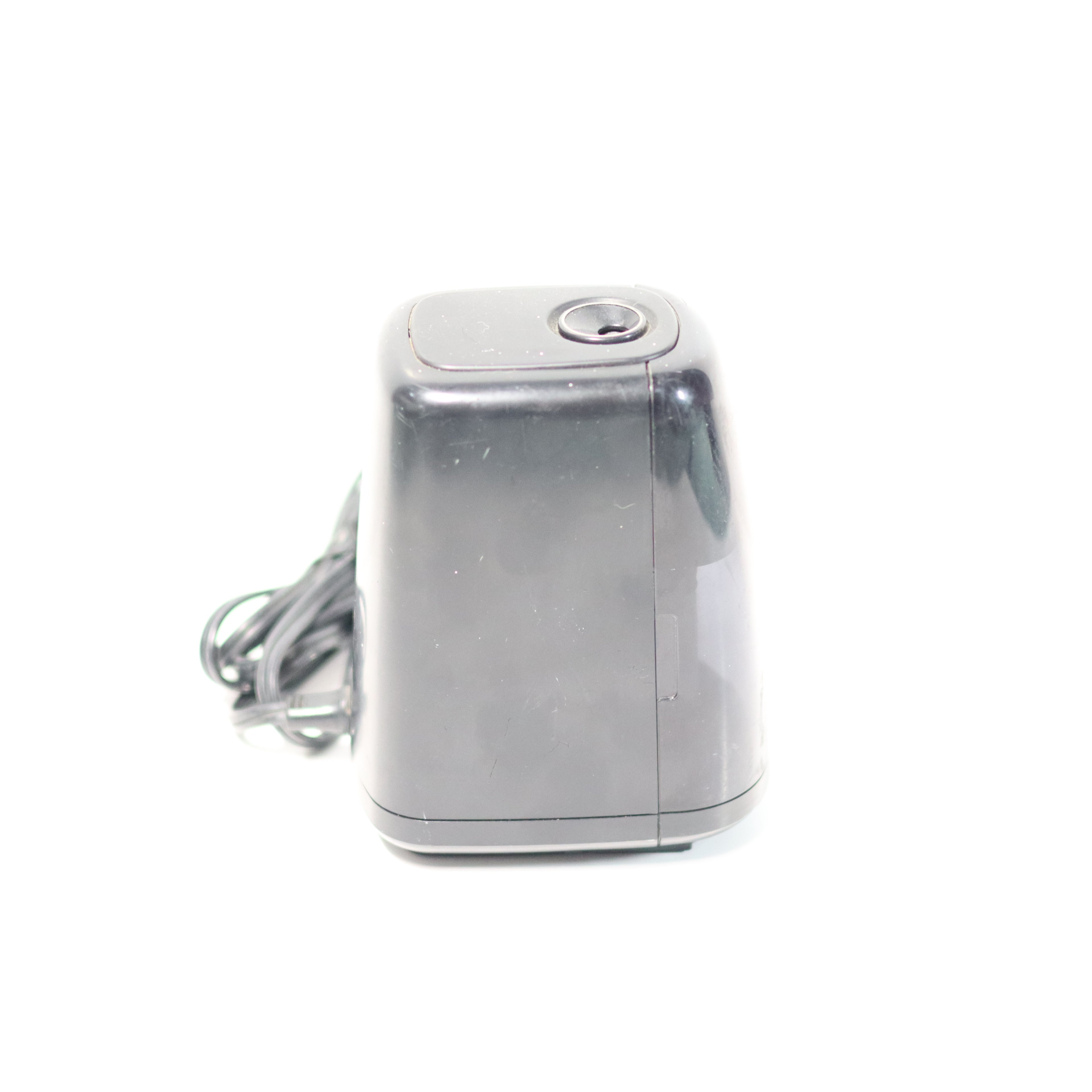 Silver electronic device with a cord on a white background