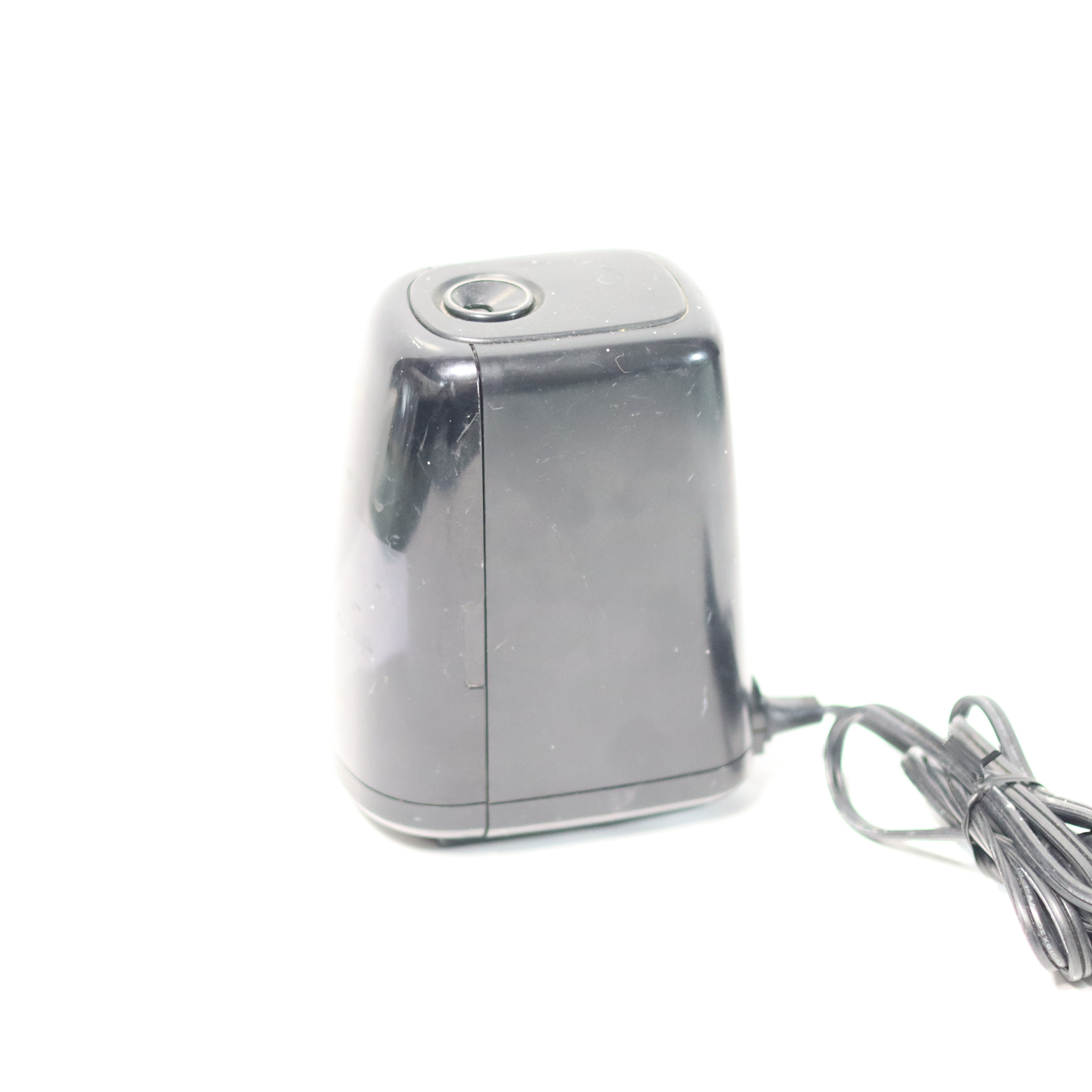 Metallic device with a cord on a white background