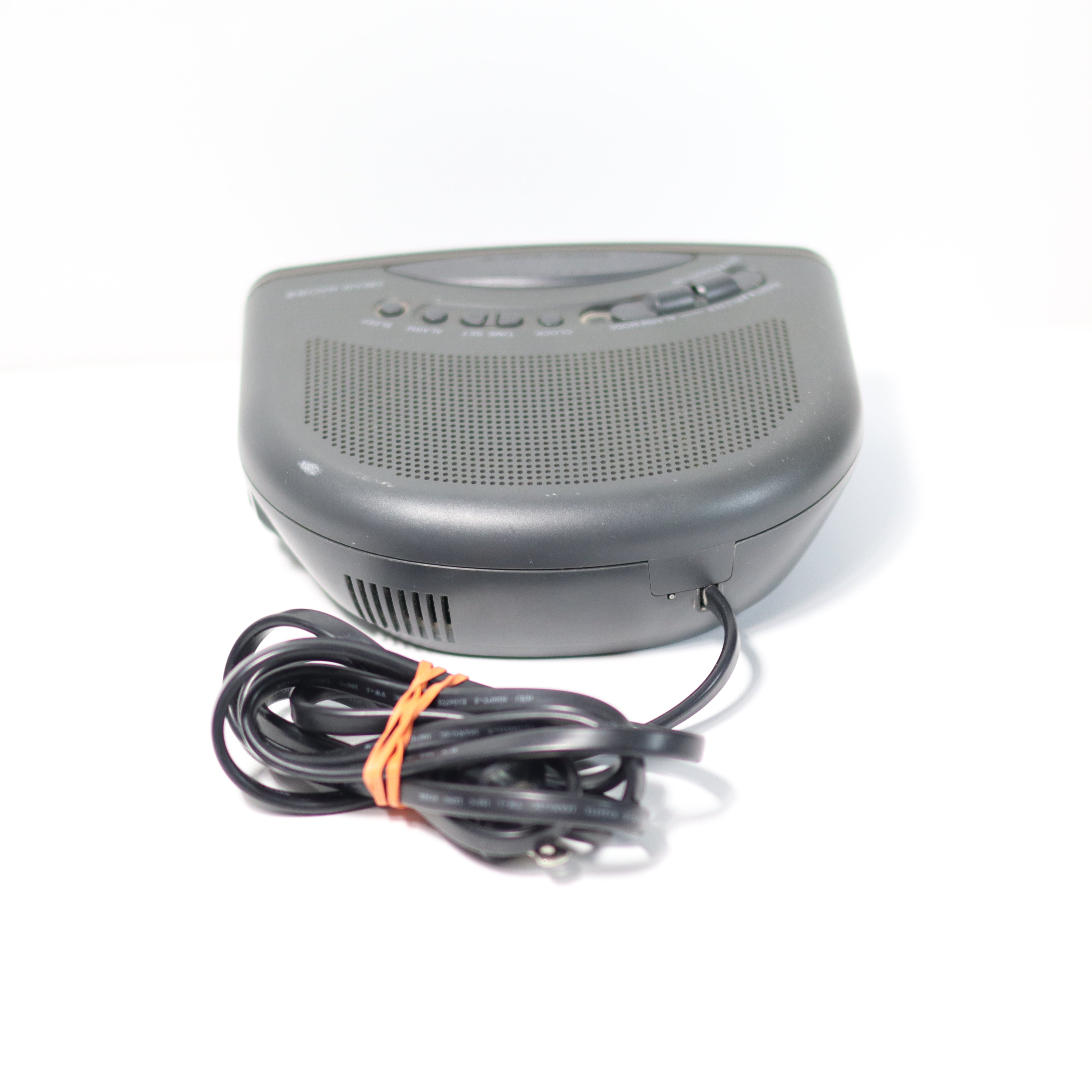 Gray electronic device with a coiled cable on a white background