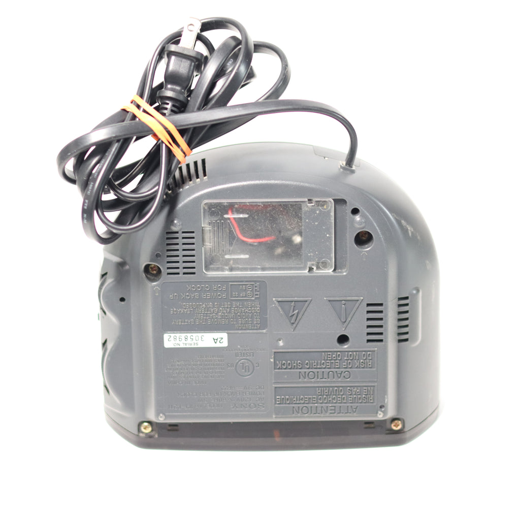 Back view of a gray electronic device with visible wiring on a white background