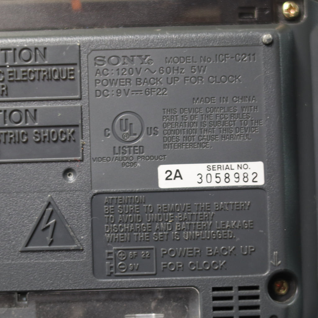 Back panel of a Sony electronic device with text and certification logos.