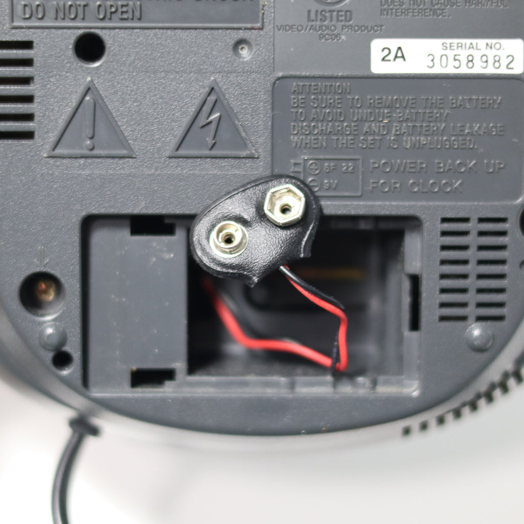 Close-up of a electronic device's battery compartment with visible wiring.