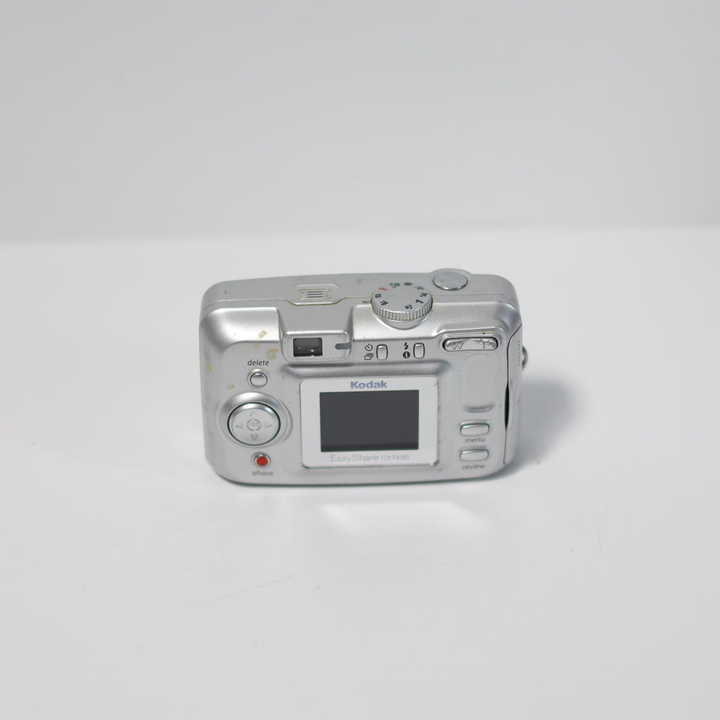 Silver Kodak digital camera on a white background