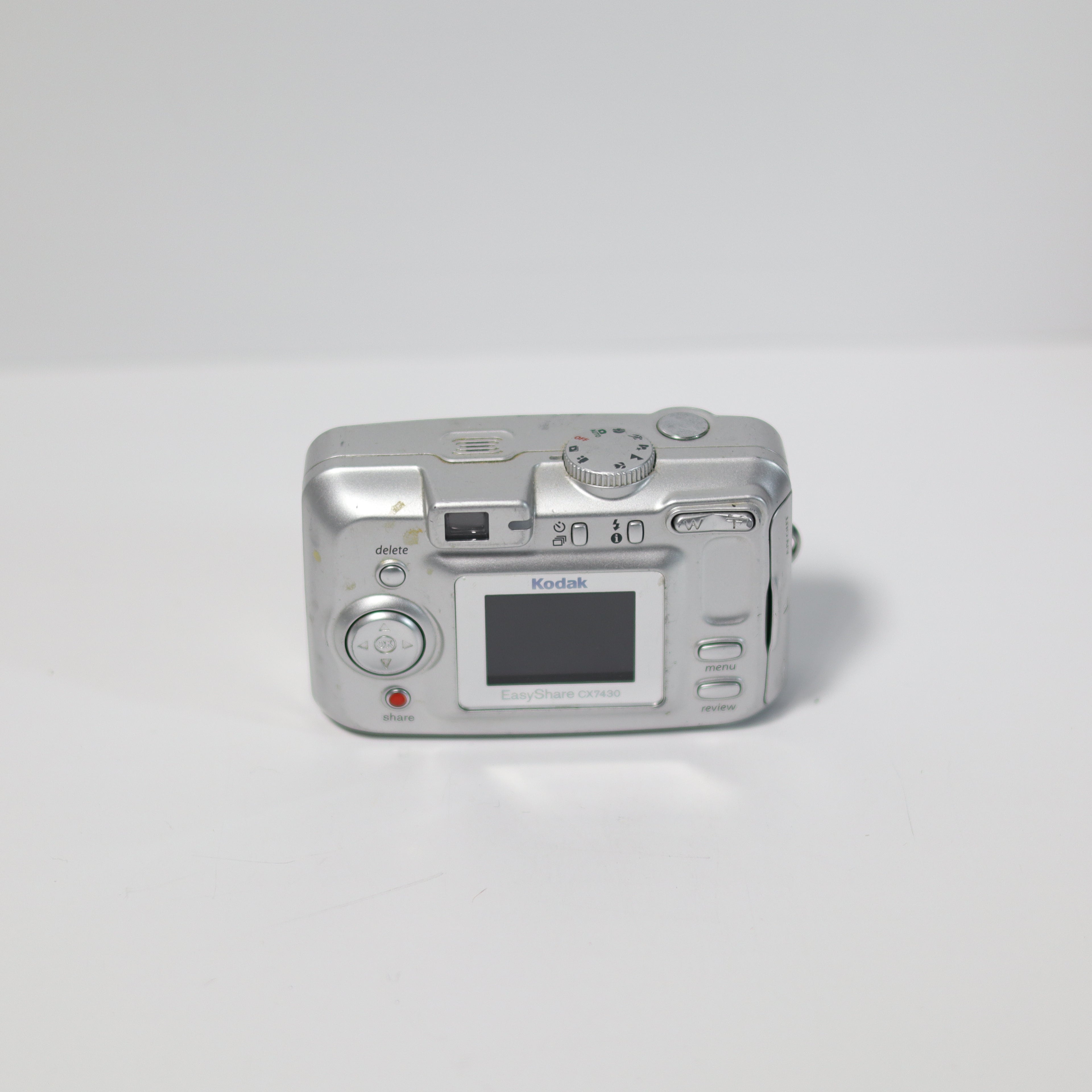 Silver Kodak digital camera on a white background