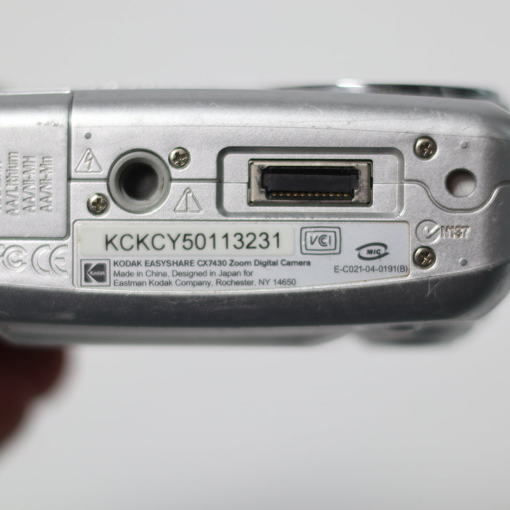Back view of a digital camera with branding and model number on a white background