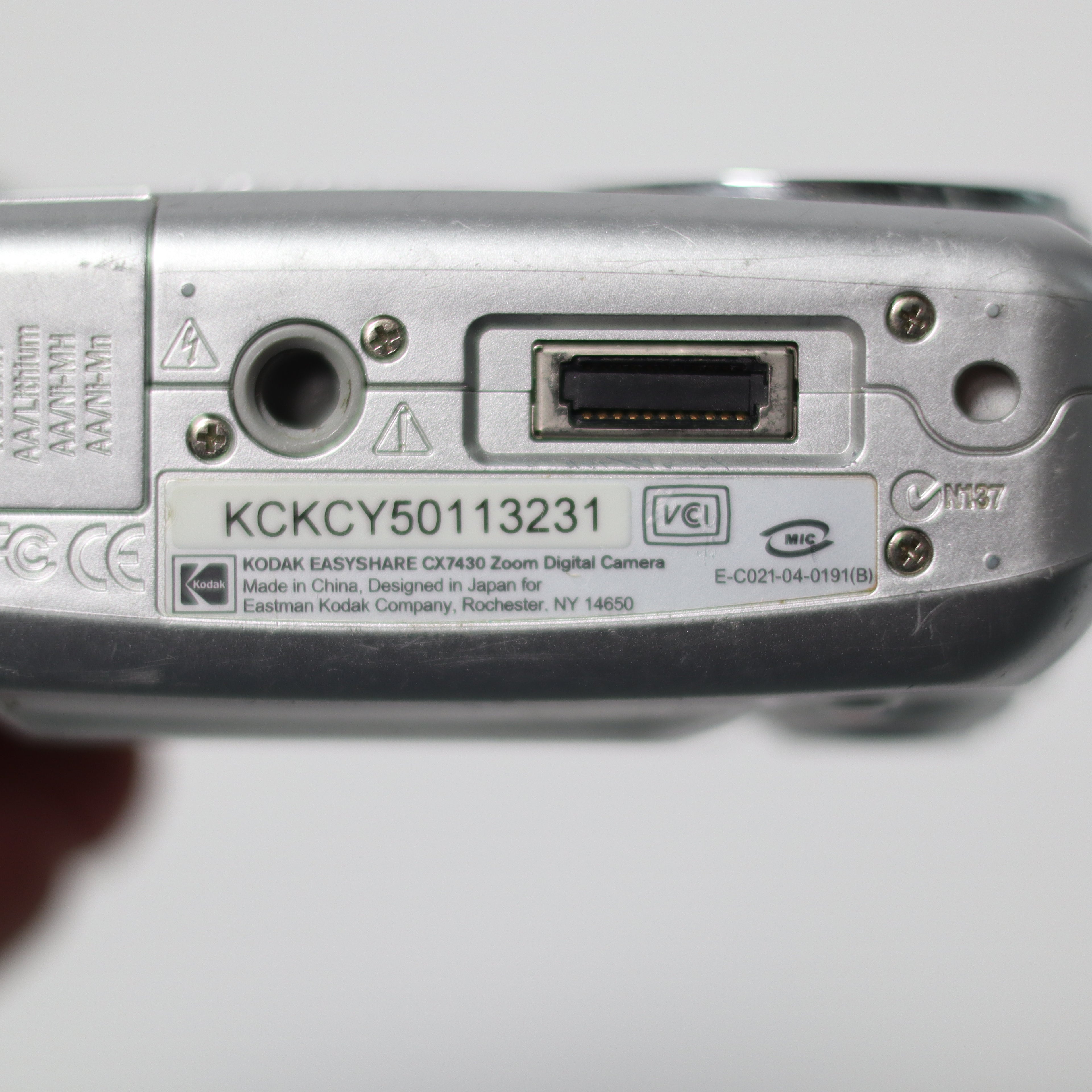 Back view of a digital camera with branding and model number on a white background