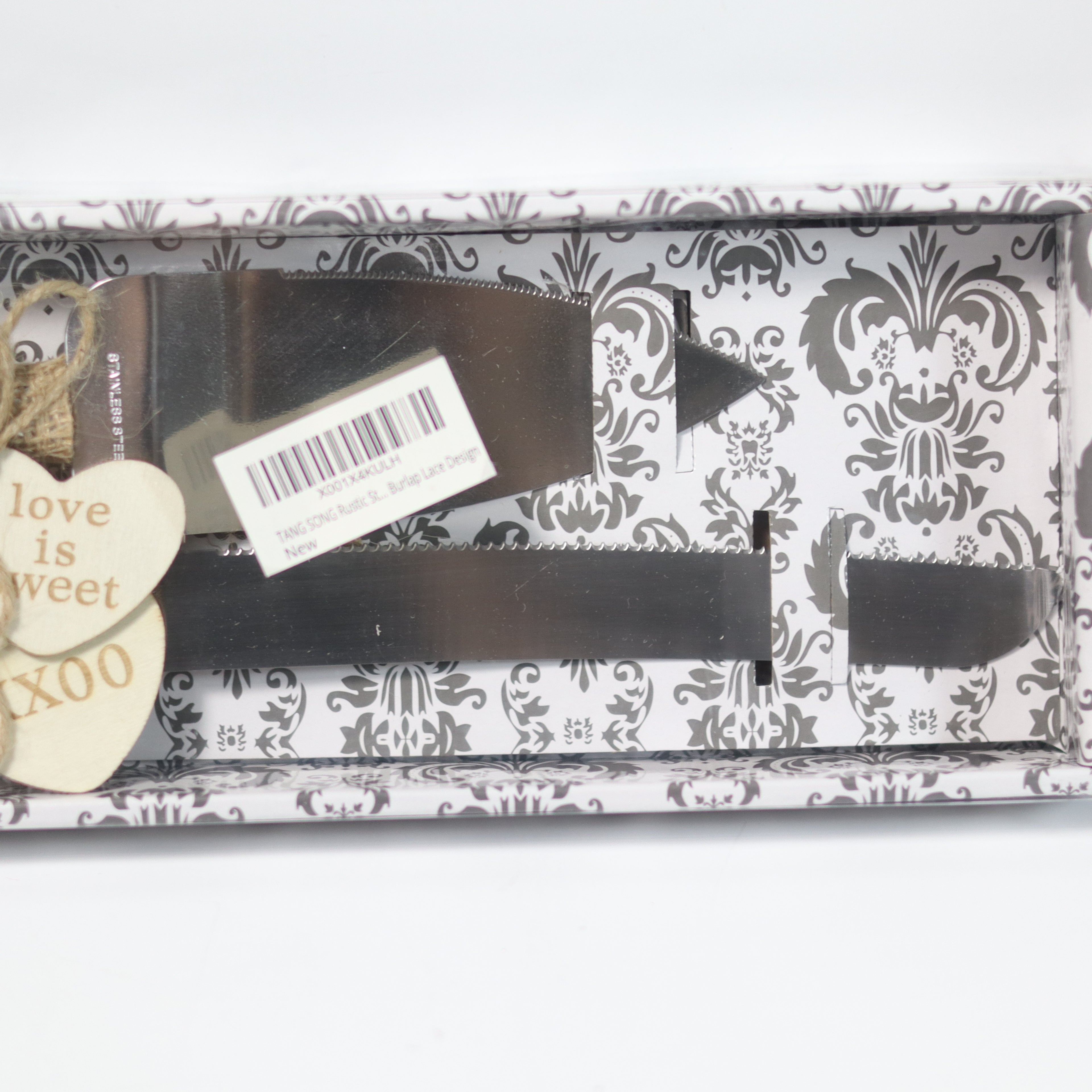 Black hair straightener with decorative packaging featuring a heart-shaped tag and text.