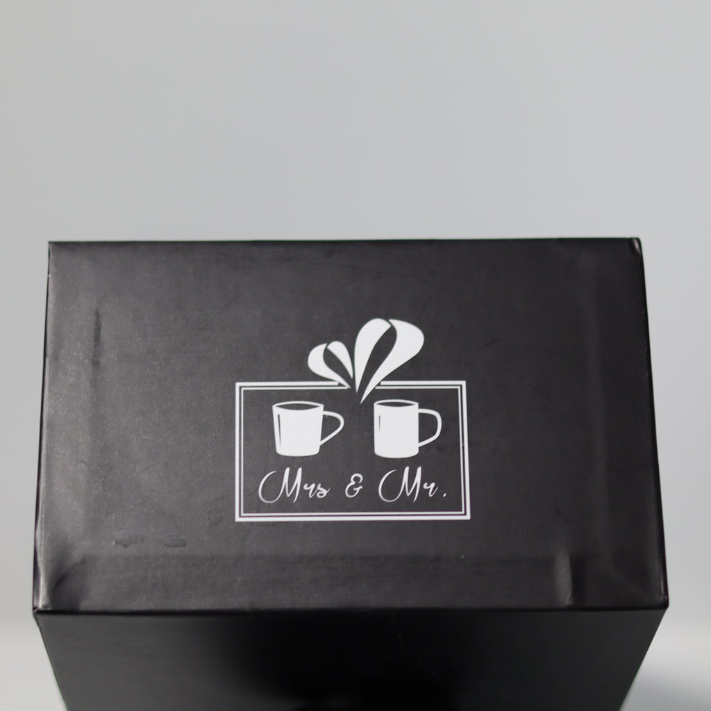 Black box with 'Mrs & Mr.' design on a gray background