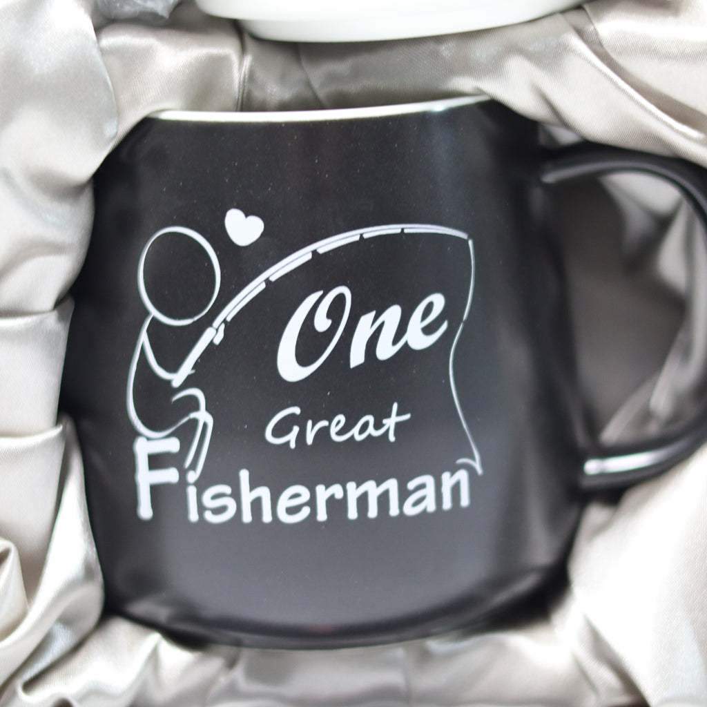 Black mug with 'One Great Fisherman' text and design on a white blanket