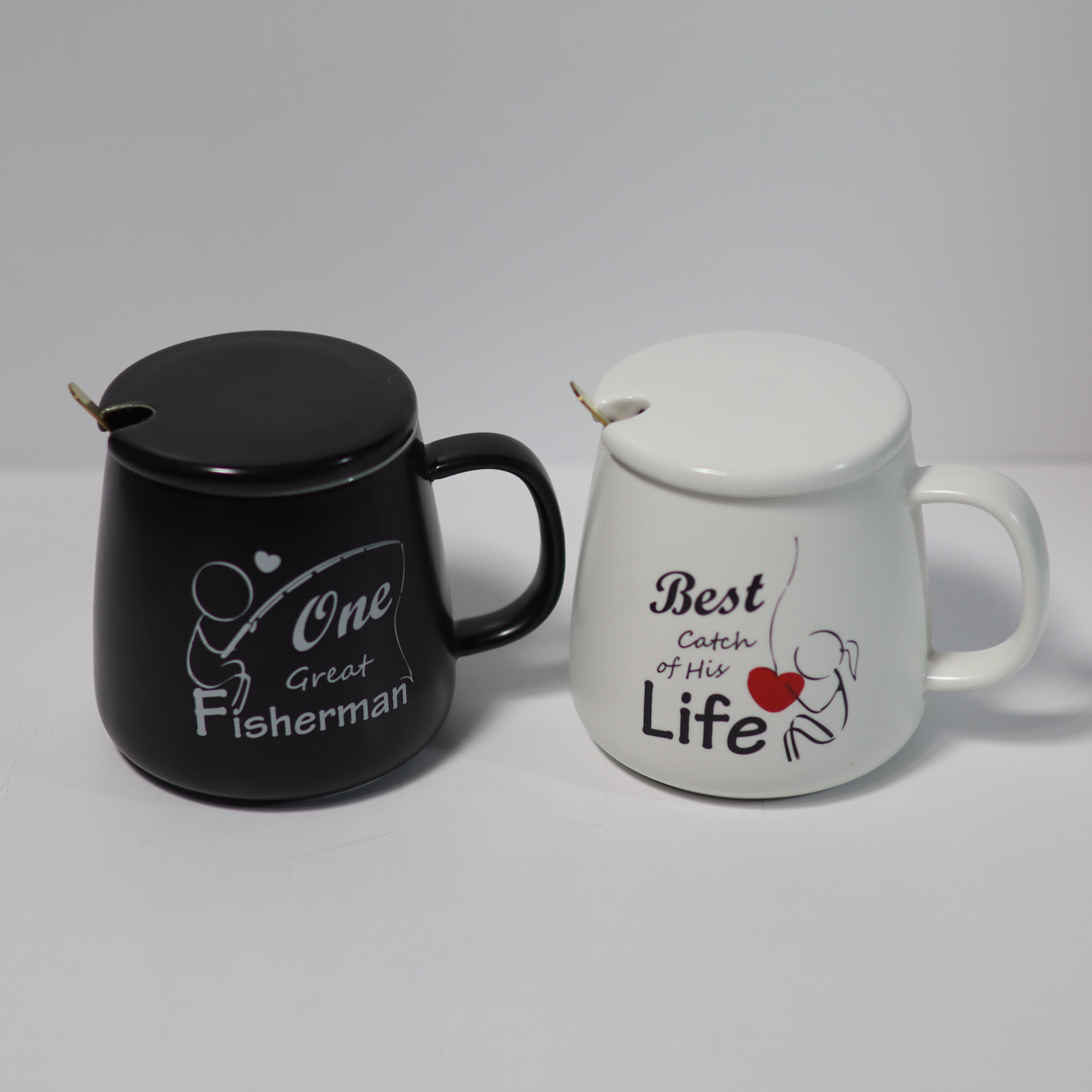 Black mug with 'One Great Fisherman' text and white mug with 'Best Catch of His Life' text on a gray background