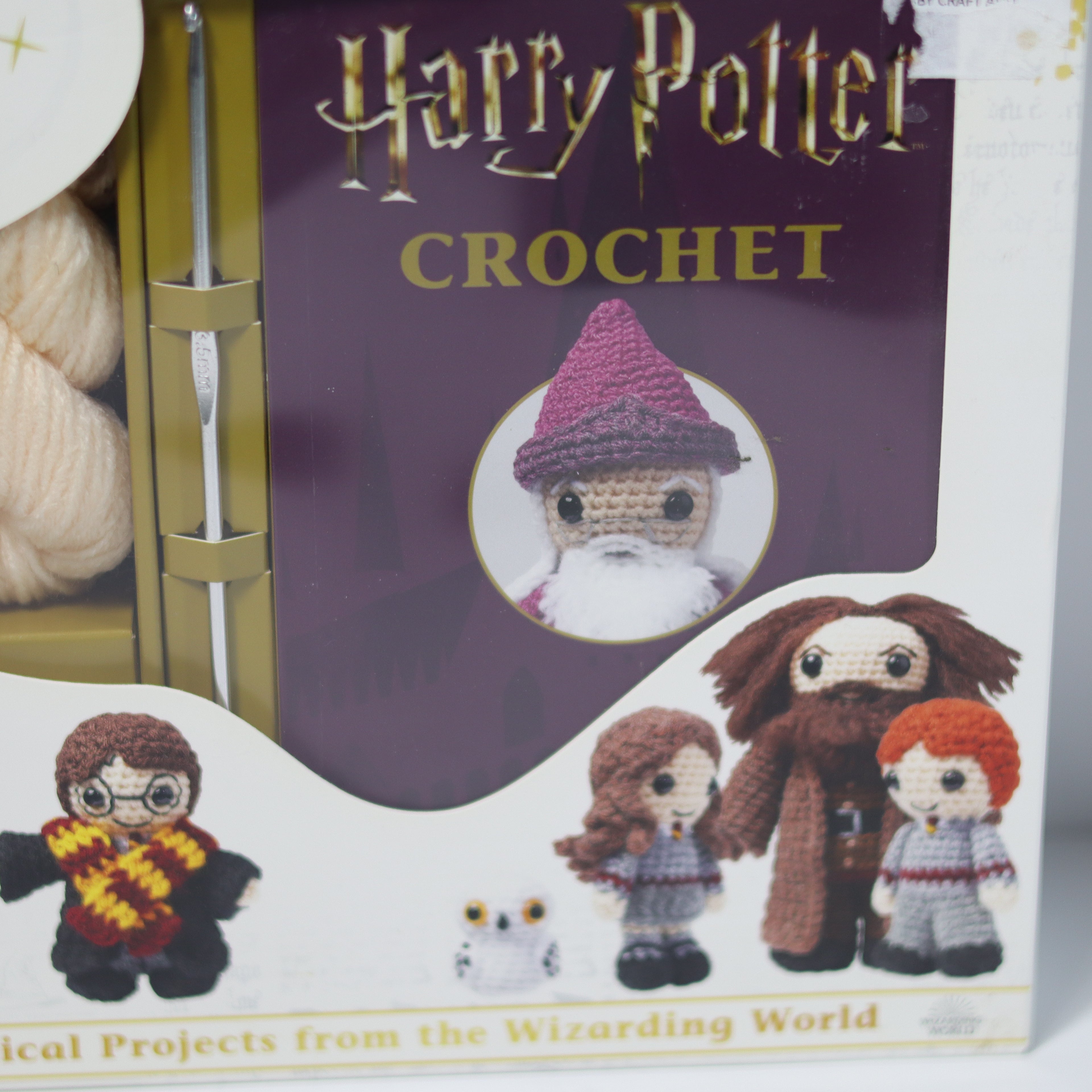 Crochet kit packaging with Harry Potter-themed dolls and yarn on a white background