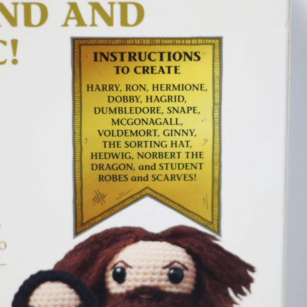 Crocheted character with a sign detailing character names and instructions on a white background